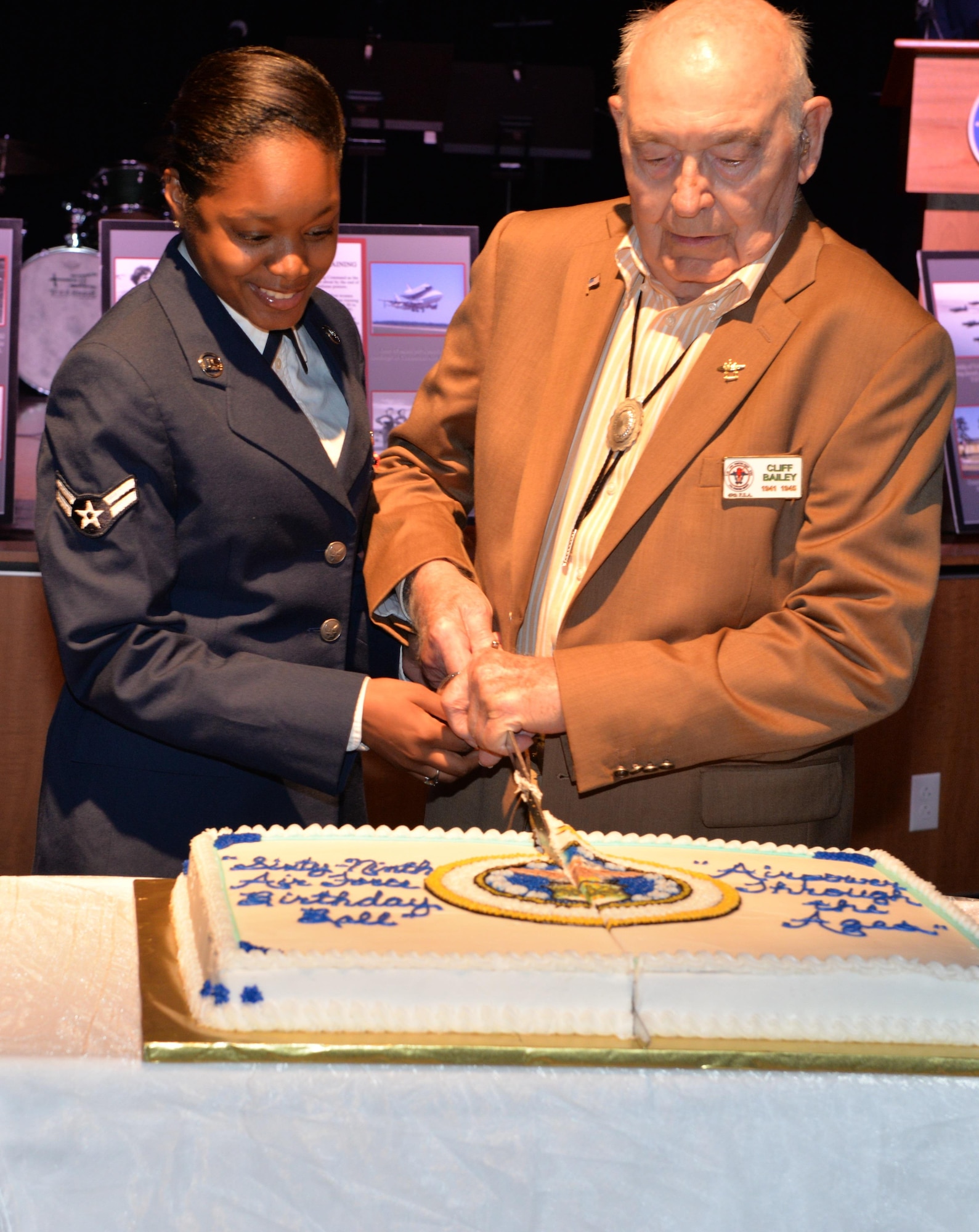 Airman 1st Class Kelsey Ganter, 37th Flying Training Squadrons Aviation Resource Manager, and Clifton Bailey, who was one of over 20 members of the 49th Fighter Squadron Reunion, cut the cake during the 69th Air Force Birthday Ball Sept. 17 at the Trotter Convention Center in Columbus, Mississippi. The ceremonial Air Force Birthday Ball cake is traditionally cut by the oldest and newest Airmen present for the party. (U.S. Air Force photo by Richard Johnson)