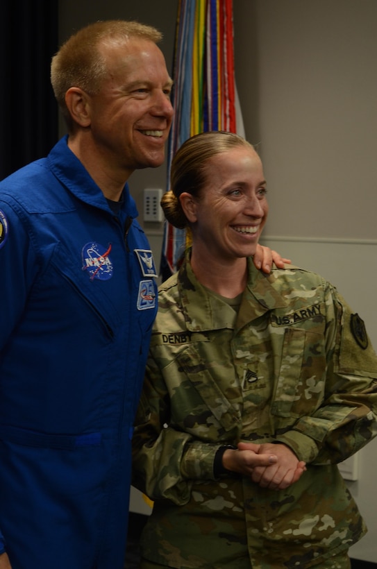 NASA astronaut Timothy Kopra (left) and Defense Information School Public Affairs instructor Staff Sgt. Heather Denby (right) smile for the camera following his presentation at DINFOS, Fort Meade, Md., Sept. 13, 2016. Kopra’s visit enlightened students and staff about his experience aboard Expedition 47.