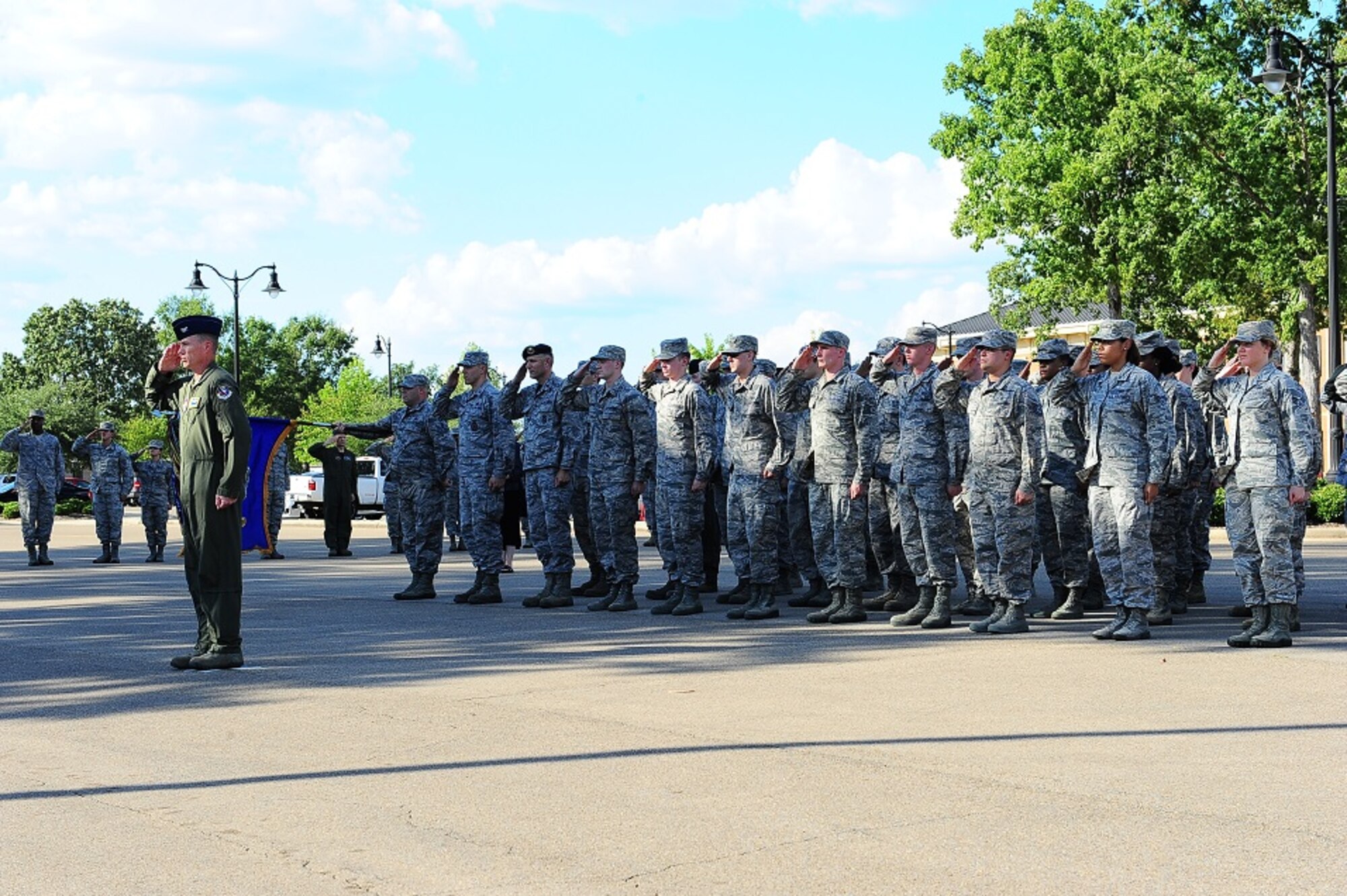More than 30 Team BLAZE Airmen stand in formation behind Col. Douglas Gosney, 14th Flying Training Wing Commander, and salute the flag during a retreat ceremony honoring men and women who are Prisoners of War or Missing in Action Sept. 16 in Smith Plaza at Columbus Air Force Base, Mississippi. Ceremonies are encouraged throughout POW/MIA Recognition Week, culminating with countless events and the national ceremony in Washington, DC. (U.S. Air Force photo by Senior Airman Kaleb Snay)
