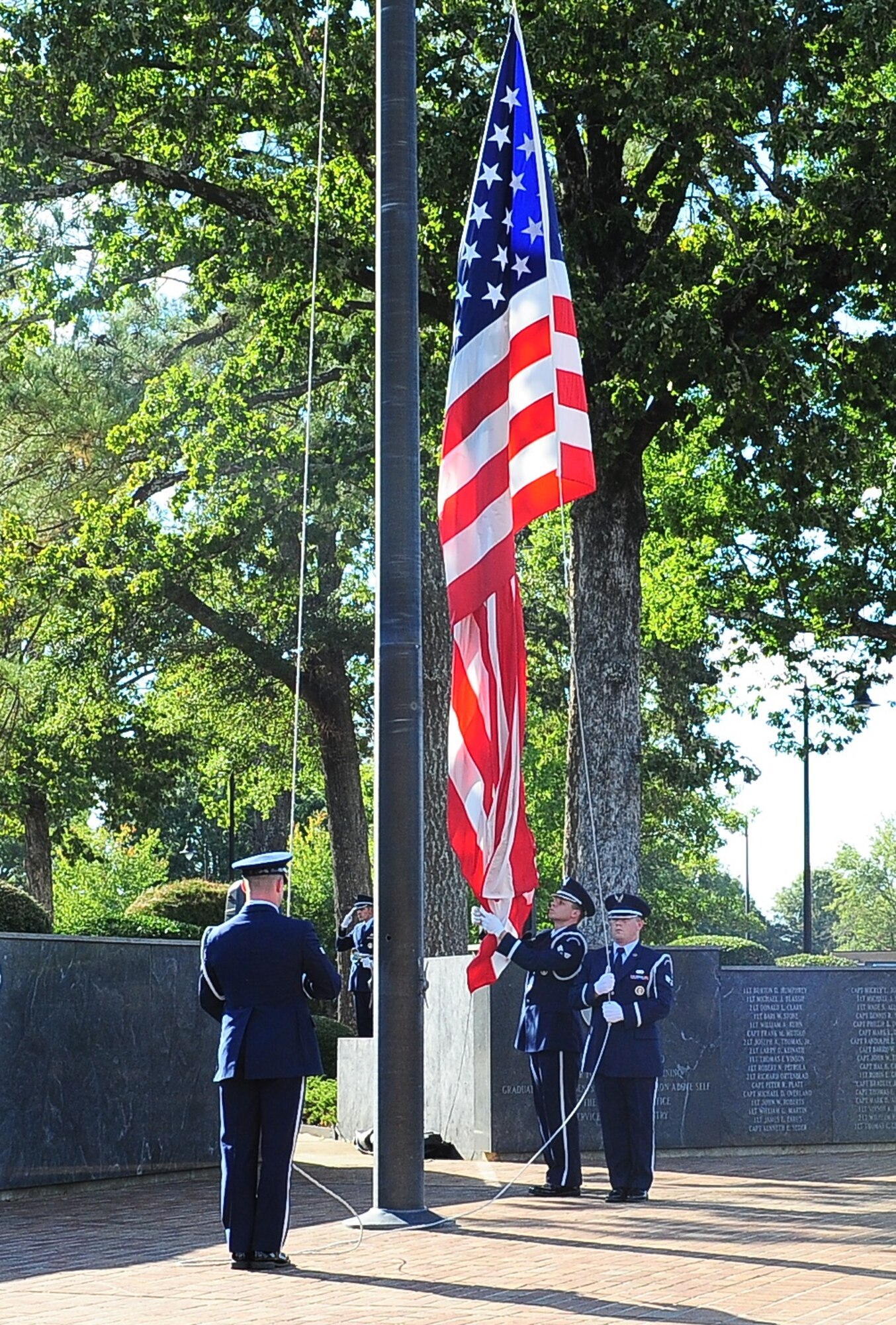 Columbus Air Force Base Honor Guardsmen lower the flag during a retreat ceremony honoring men and women who are Prisoners of War or Missing in Action Sept. 16 in Smith Plaza at Columbus Air Force Base, Mississippi. The annual event honors missing service members and their families, and highlights the government’s commitment to account for them. (U.S. Air Force photo by Senior Airman Kaleb Snay)