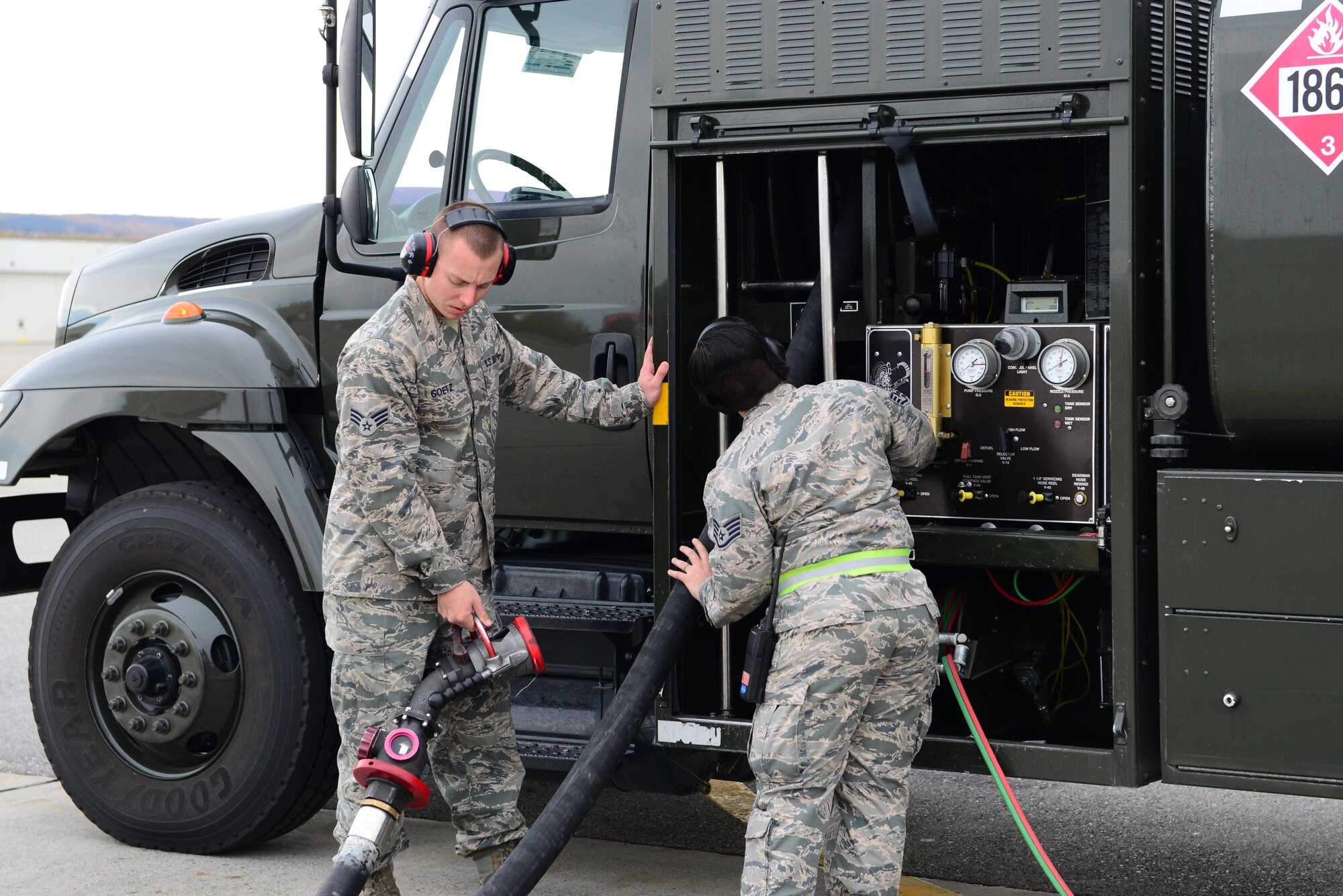 U.S. Air Force Senior Airman Jacob Goetz, a 354th Logisitics Readiness Squadron (LRS) fuels distribution operator, and Staff Sgt. Jade Finley, a 354th LRS fuels distribution supervisor, wind a fuel pump back up after a hot pit refueling of F-16 Fighting Falcon jets Sept. 20, 2016, at Eielson Air Force Base, Alaska. The hot pits refueling is done for a quick turnaround of aircraft, lasting about 20 minutes versus the usual three hours. (U.S. Air Force photo by Airman 1st Class Cassandra Whitman)