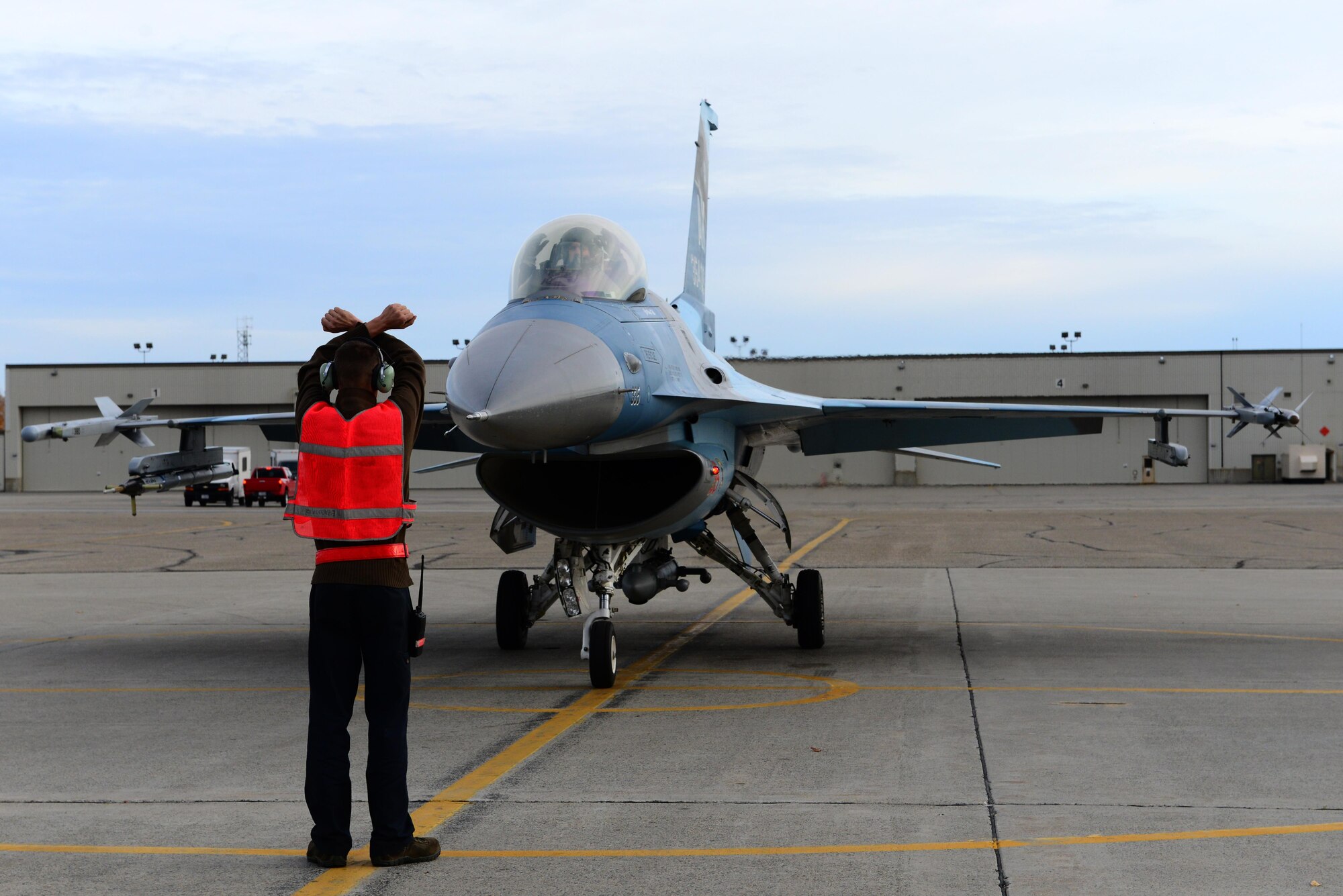 U.S. Air Force Staff Sgt. Eric Sandberg, a 354th Aircraft Maintenance Squadron crew chief, directs Col. Brian Toth, the 354th Operations Group commander, into place Sept. 20, 2016, at Eielson Air Force Base, Alaska. Toth participated in a hot pit, which is when a jet is refueled while running. (U.S. Air Force photo by Airman 1st Class Cassandra Whitman)