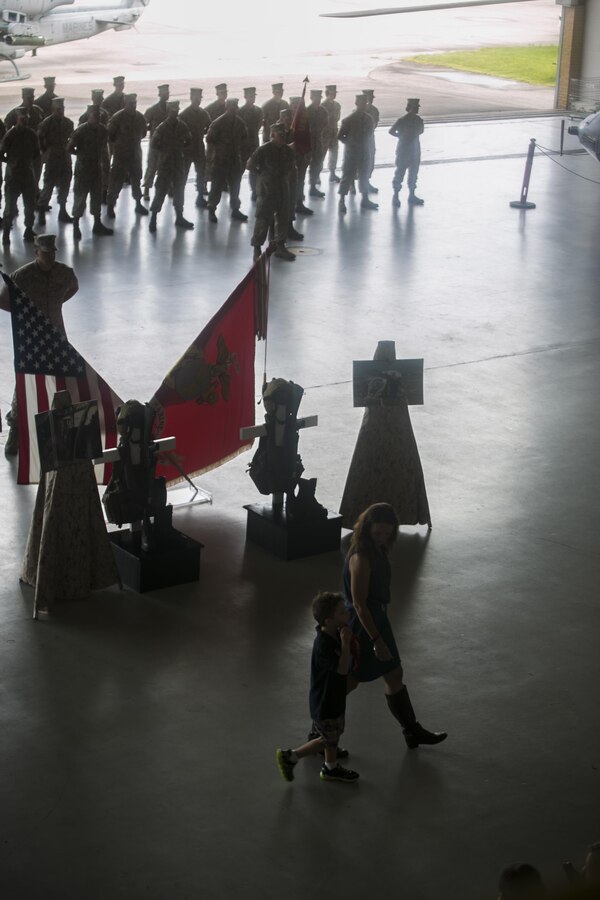 Lynn Grogan walks her son, Aaron back to their seats during a memorial ceremony held for her husband Sept. 18, 2016, at Naval Air Station Joint Reserve Base New Orleans, La. Maj. Jason Grogan and Maj. Erik A. Boyce were killed July 6, 2016, when the Bell 525 helicopter they were piloting crashed near Arlington, Texas. Grogan and Boyce were both assigned to Marine Light Attack Helicopter Squadron 773, Detachment A, at NAS JRB New Orleans at the time of their deaths.