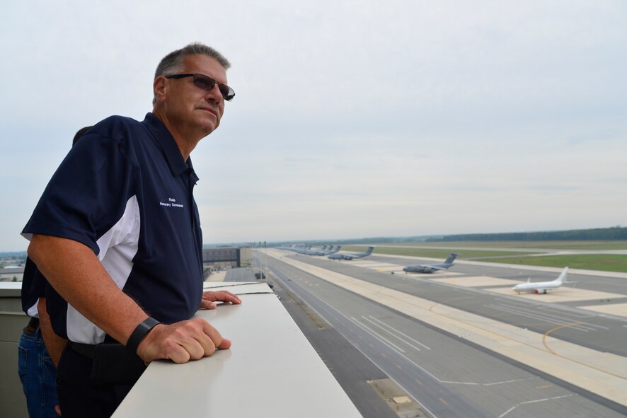 Robb Carter, Joint Personal Effects Depot honorary commander, looks at the airfield during a tour of the air traffic control tower Sept. 21, 2016, at Dover Air Force Base, Del. Team Dover Honorary Commanders took part in a tour of the 436th Operations Group and received an incentive flight on a C-17A Globemaster III. (U.S. Air Force photo by Senior Airman William Johnson)
