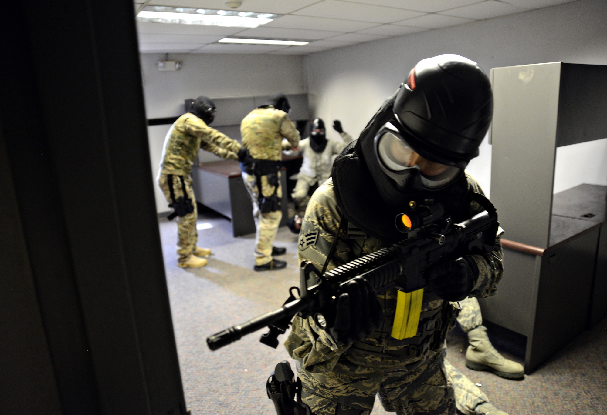 With one threat identified, a Tinker Airman continues to sweep the area for more subjects during active shooter training. (Air Force photo by Kelly White)