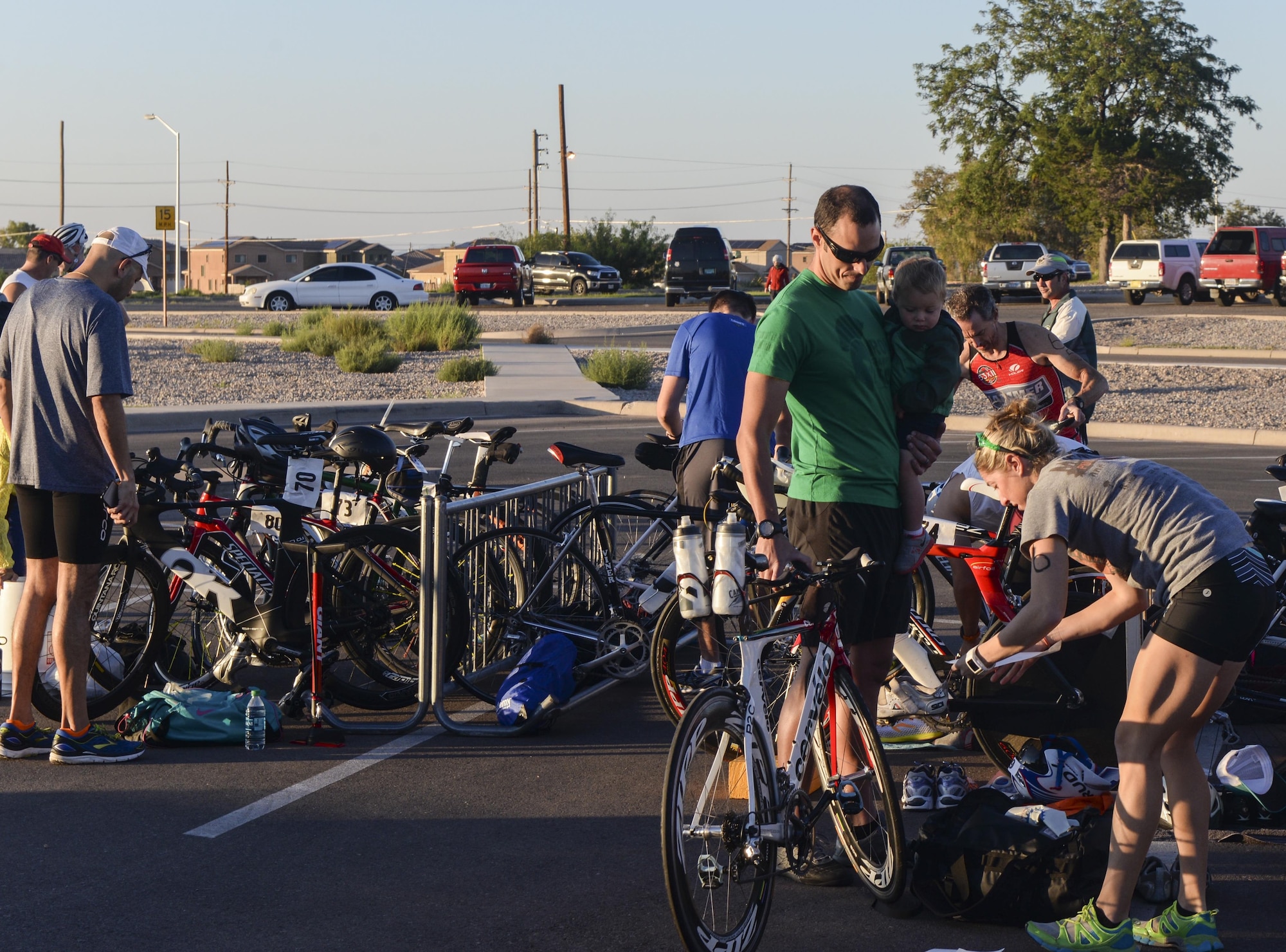 A group of athletes prepare their equipment before Holloman’s eighth annual Monster Triathlon at Holloman Air Force Base, N.M. on Sept. 17, 2016. Race participants were required to bring their own bikes, helmets and swim gear to the event. (U.S. Air Force photo by Airman 1st Class Alexis P. Docherty)