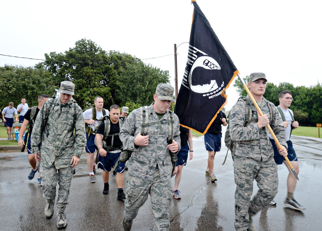 Team Tinker members participated in a 5K/10K ruck march around the base in memory of Prisoners of War and those Missing In Action Sept. 16. Participants were asked to bring canned food items that were distributed at checkpoints along their route. As they marched on and hit the checkpoints, they filled their rucks with the canned items to symbolize the hardships that POWs and MIAs went through. The canned goods were later donated to the Airmen and Family Readiness Center’s Food Pantry. (Air Force photo by Kelly White)