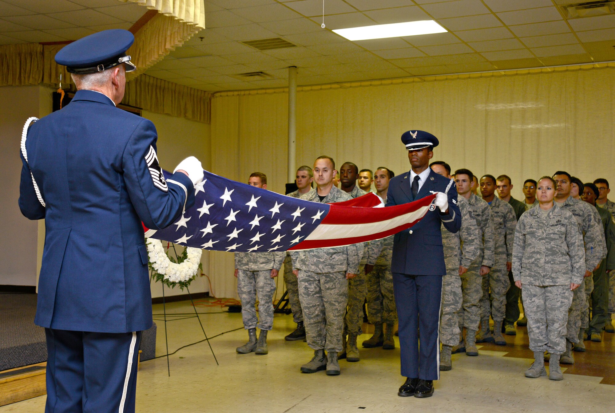 Members of the Tinker Honor Guard perform a flag-folding ceremony in front of members of Team Tinker at the Del City American Legion and VFW Post 9969 Sept. 16 as part of a POW/MIA Retreat ceremony. (Air Force photo by Kelly White)