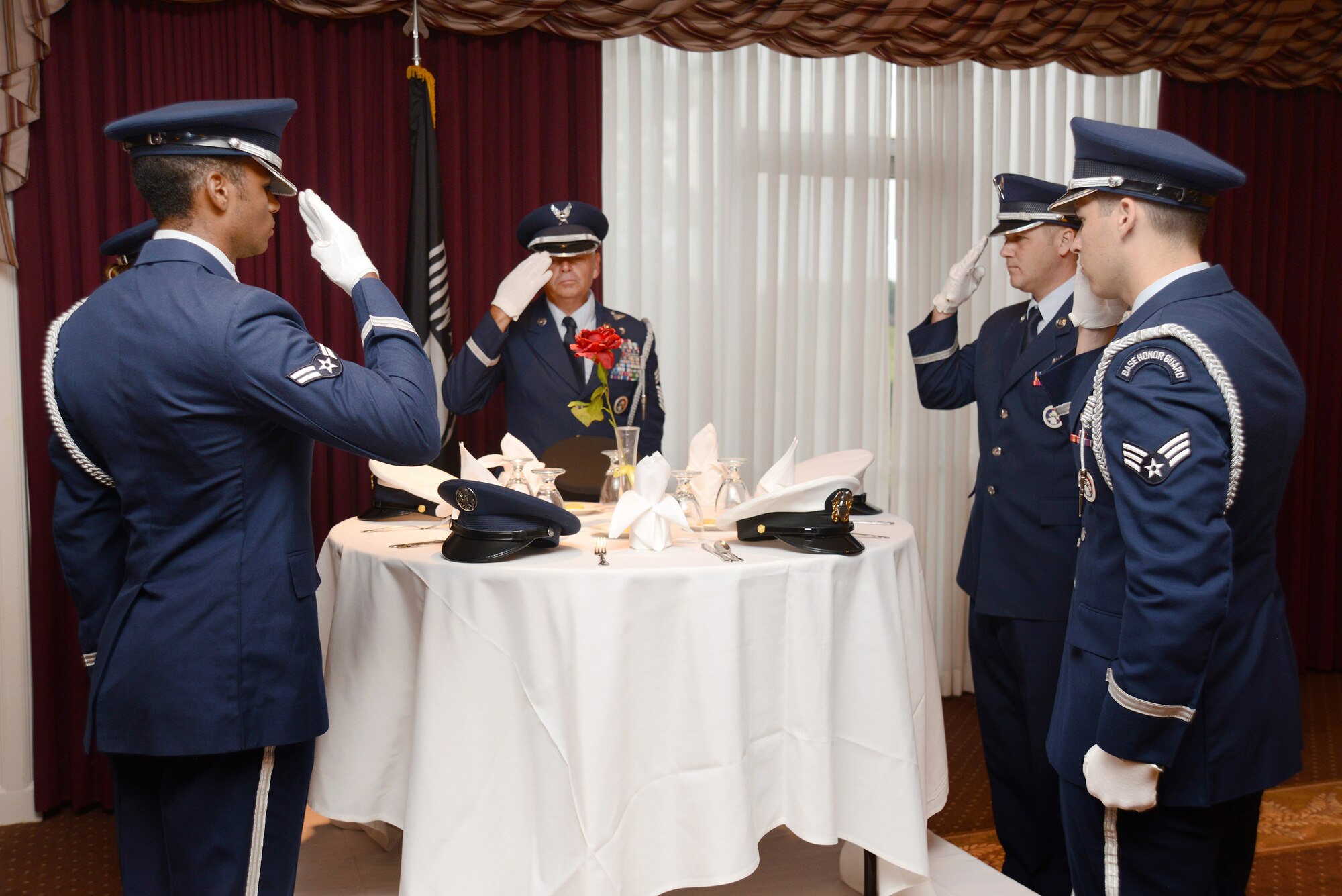 Members of the Tinker Honor Guard perform the POW/MIA Ceremony during the Sept. 9 breakfast. The ceremony is steeped in significance, with every item from the table to the rose, being symbolic of the sacrifices of those who were captured or of those who never returned home.  (Air Force photo by Kelly White)