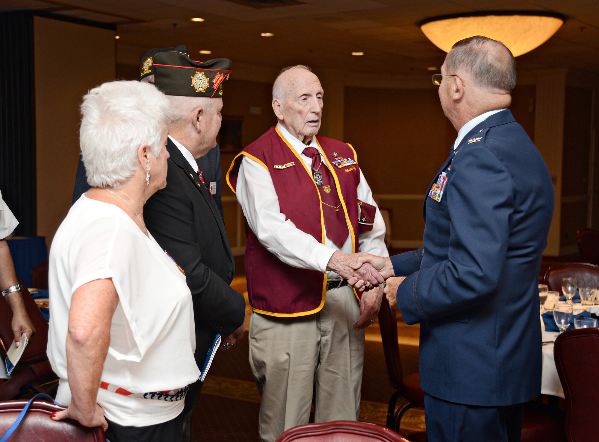 Retired Col. Charles DeBellevue shakes hands with U.S. Army Private First Class Charles Selby, an ex-POW who was held in captivity for 998 days in North Korea. Colonel DeBellevue was the guest speaker at the POW/MIA Breakfast Sept. 16 at the Tinker Club. (Air Force photo by Kelly White)