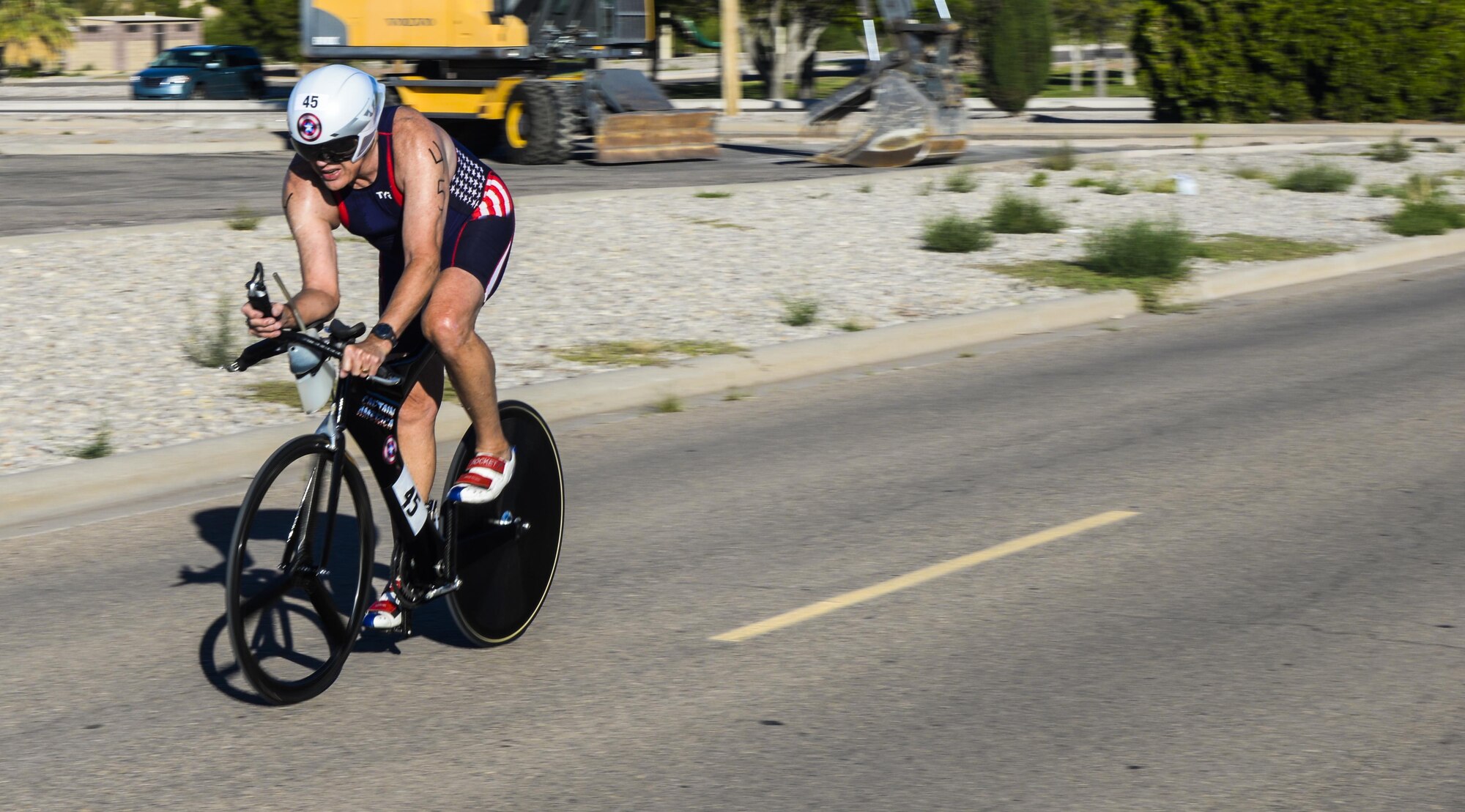 A cyclist swiftly rounds a corner during Holloman’s eighth annual Monster Triathlon at Holloman Air Force Base, N.M. on Sept. 17, 2016. Many race participants wore a hydrodynamic form of exercise attire called speedsuits. (U.S. Air Force photo by Airman 1st Class Alexis P. Docherty)