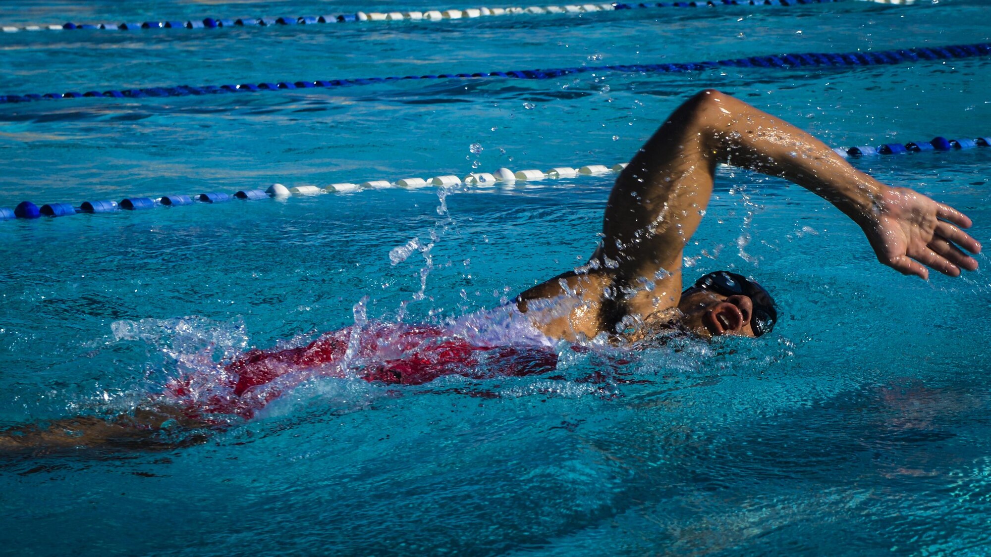 An athlete slices through Holloman’s Olympic-sized recreational pool during Holloman’s eighth annual Monster Triathlon at Holloman Air Force Base, N.M. on Sept. 17, 2016. Holloman’s triathlon is a three-part athletic competition that includes a 5 km run, a 30 km bike race and a 700 meter swim. (U.S. Air Force photo by Airman 1st Class Alexis P. Docherty)