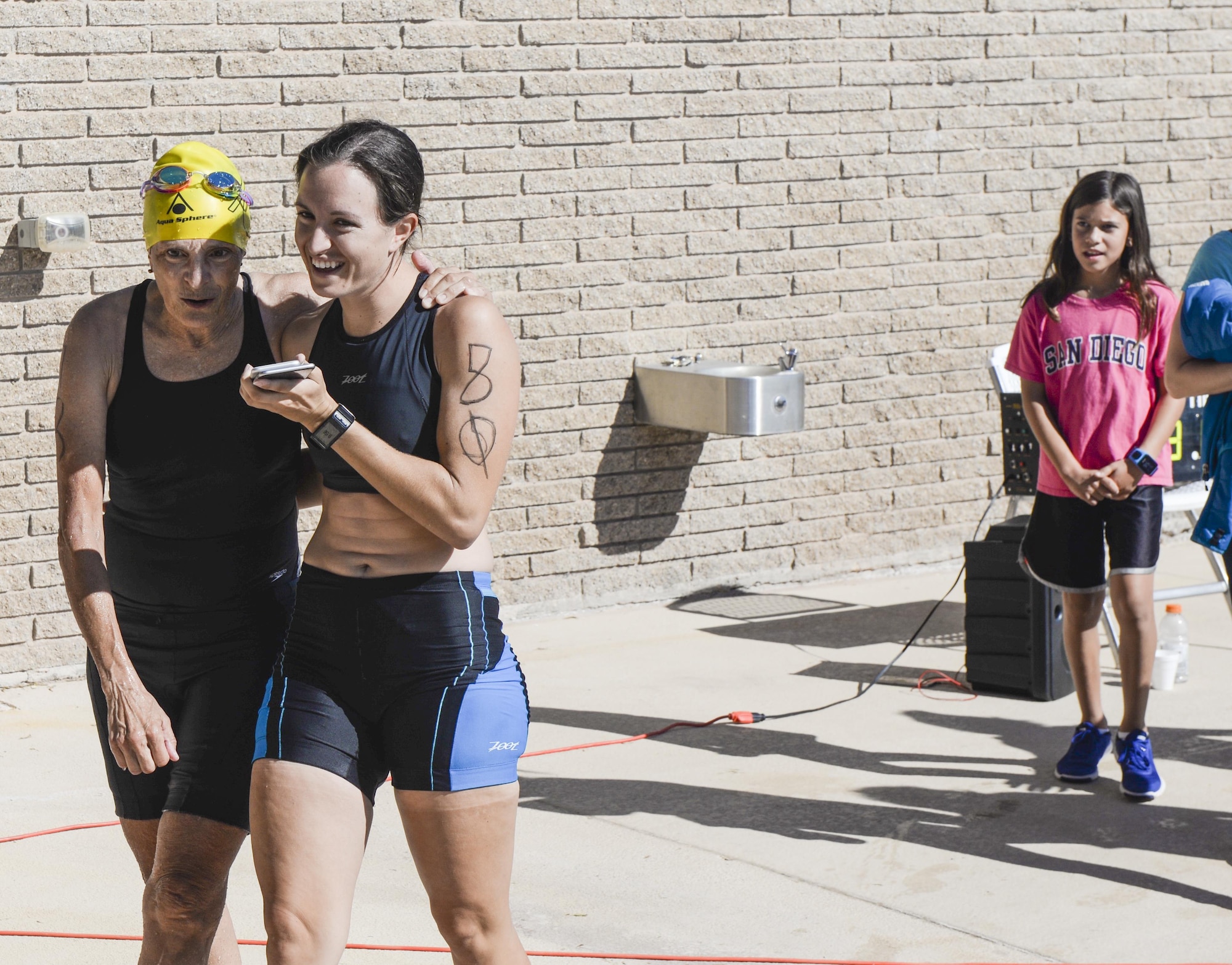 A mother-and-daughter duo share a hug after competing in Holloman’s eighth annual Monster Triathlon at Holloman Air Force Base, N.M. on Sept. 17, 2016. Race participants were able to compete solo or in teams, with family members or friends. (U.S. Air Force photo by Airman 1st Class Alexis P. Docherty)