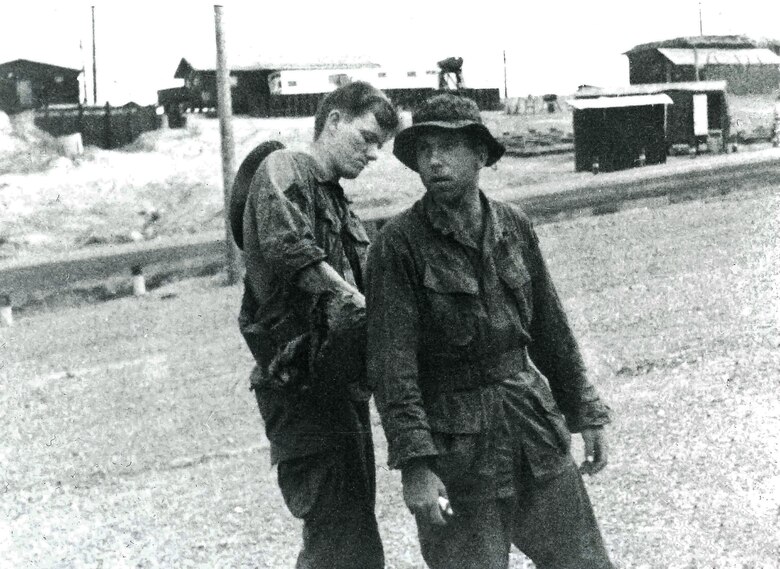 Army Specialists Jerry Rifkin (right) and Walt Rymzowicz prepare for a mission at night in Vietnam. The paper in Rifkin’s right hand had a code word to use for air support that was difficult to decipher in the dark. 