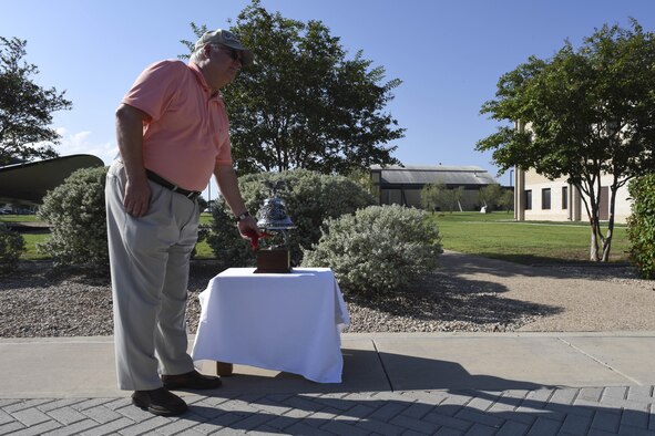 Retired Maj. Larry Miller, rings a bell to symbolize the 36 killed in action during the 6994th missions at the Norma Brown building on Goodfellow Air Force Base, Sept. 22, 2016. The 6994th was responsible for locating and identifying the enemy using airborne radio direction finding techniques 1966 to 1974. (U.S. Air Force photo by Airman 1st Class Chase Sousa/Released)