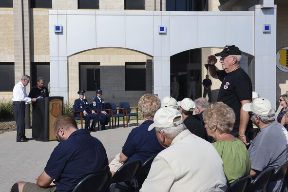 A 6994th Security Squadron 50th anniversary attendee stands for his fallen comrades at the Norma Brown building on Goodfellow Air Force Base, Sept. 22, 2016. The anniversary paid tribute to the 36 Americans that died during the 6994th missions. (U.S. Air Force photo by Airman 1st Class Chase Sousa/Released)