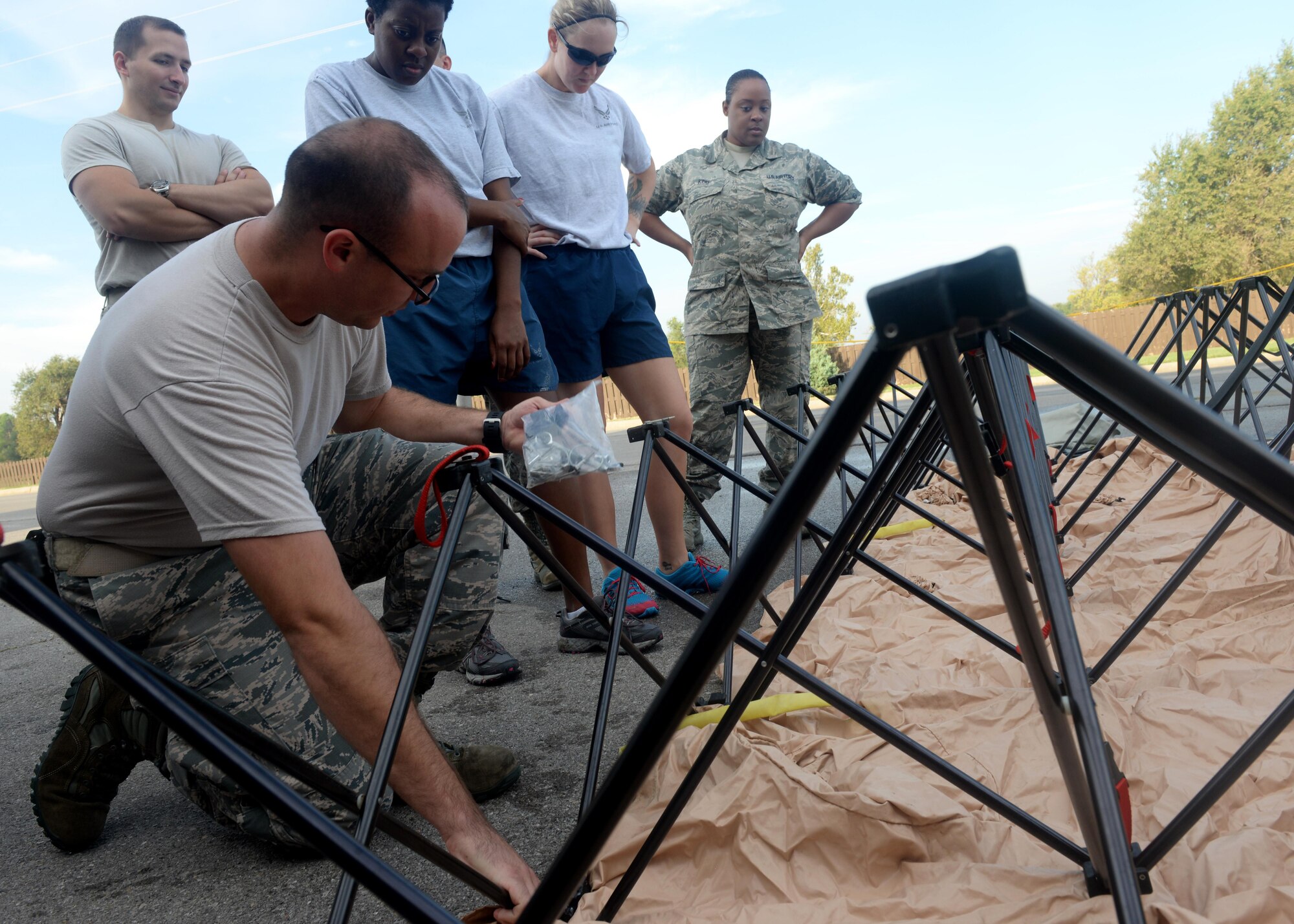 U.S. Air Force Staff Sgt. William Burnett Jr., 97 Medical Operations Squadron bioenvironmental engineer, instructs Airmen on Sept 21, 2016, Altus Air Force Base, Okla. This joint training prepared medical specialists from both Altus AFB and Sheppard AFB to help keep the medical centers clear of potential contaminate in the case of a chemical outbreak. (U.S. Air Force Photo by Airman Jackson N. Haddon/Released).