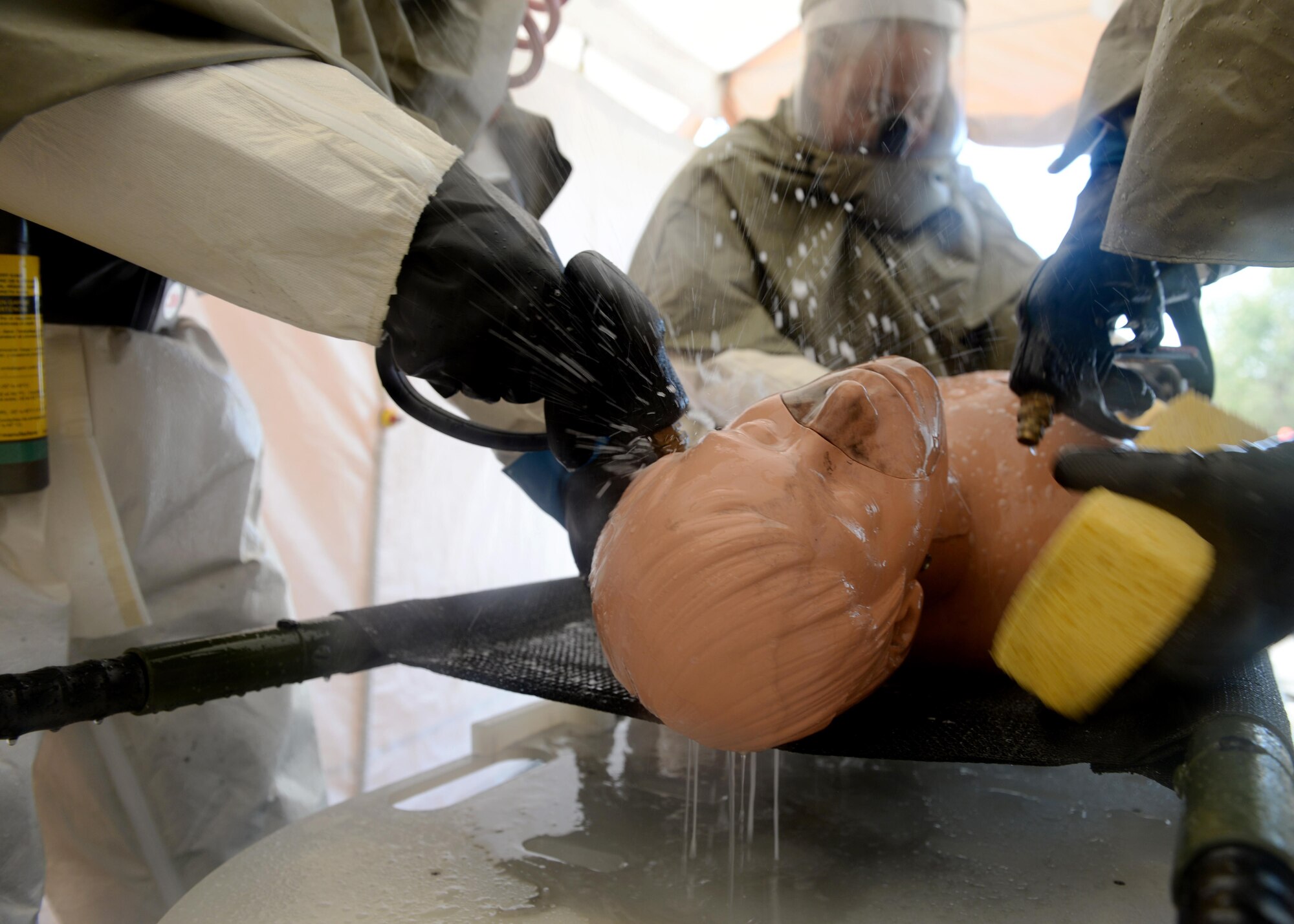 U.S. Air Force Staff Sgt. William Burnett Jr., 97 Medical Operations Squadron bioenvironmental engineer, instructs Airmen on Sept 21, 2016, Altus Air Force Base, Okla. This joint training prepared medical specialists from both Altus AFB and Sheppard AFB to help keep the medical centers clear of potential contaminate in the case of a chemical outbreak. (U.S. Air Force Photo by Airman Jackson N. Haddon/Released).