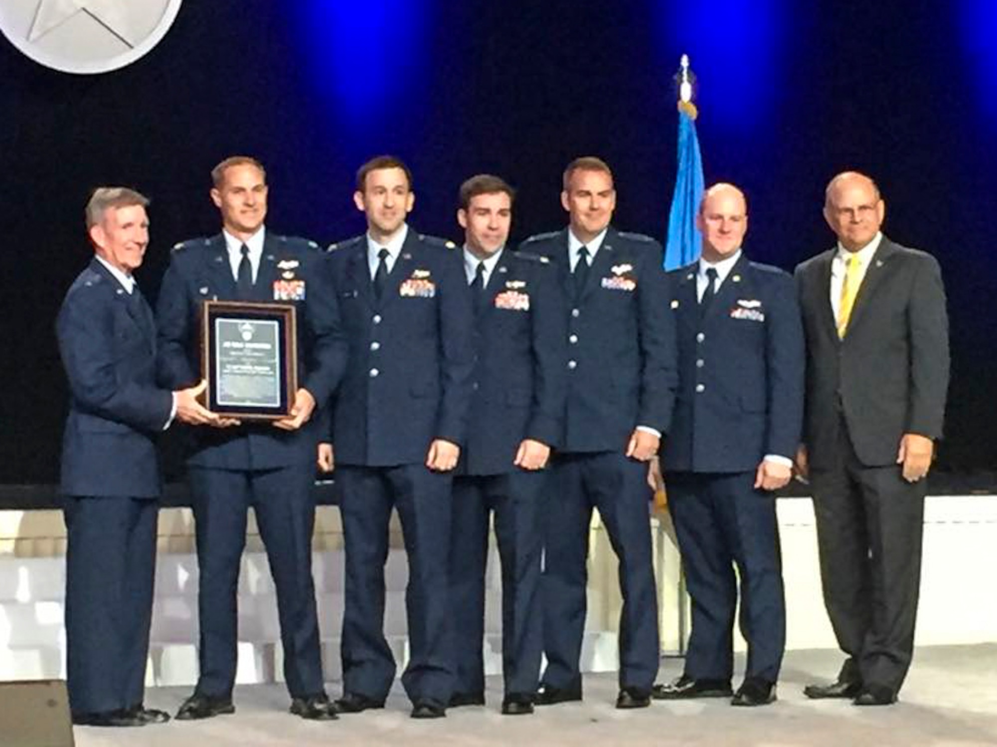Gen. Herbert Carlisle (left), Air Combat Command commander, presents Lt. Col. Lucas Teel, 336th Fighter Squadron commander, and other members of the squadron with the David. C. Schilling Award at the annual Air, Space & Cyber Conference, Sept. 19, 2016, in National Harbor, Maryland. The award is sponsored by the Air Force Association and recognizes the most outstanding contribution to national defense in the field of flight, in the atmosphere or space, by either an Air Force military member, Department of the Air Force civilian, unit or group of individuals. (Courtesy photo)