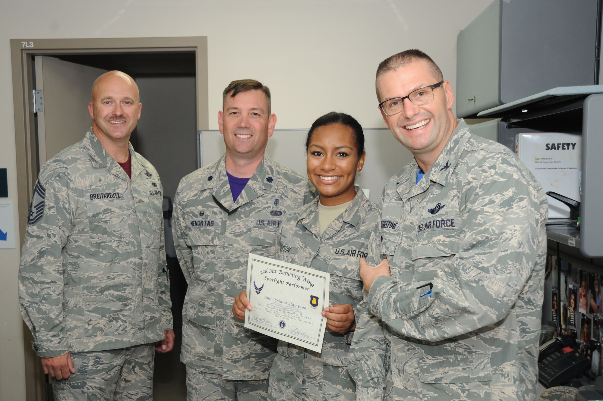 Airman Briana Hampton, 22nd Medical Support Squadron medical records technician, poses with Col. Phil Heseltine, 22nd Air Refueling Wing vice commander, Lt. Col. Lee Nenortas, 22nd Medical Support Squadron commander and Chief Master Sgt. Donald Breitkreutz, 22nd Operations Group superintendent, Sept. 23, 2016, at McConnell Air Force Base, Kan. Hampton received the spotlight performer for the week of Aug. 29 - Sept. 2. (U.S. Air Force photo/Airman 1st Class Jenna K. Caldwell)