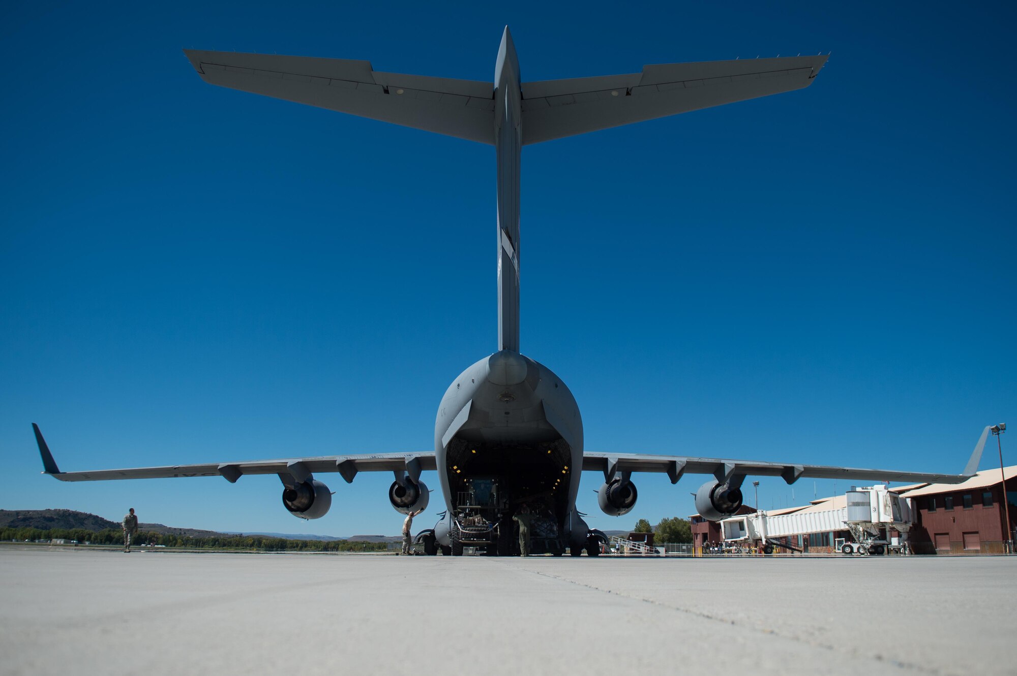 U.S. Airmen assigned to the 821st Contingency Response Group offload cargo from a C-17 Globemaster III aircraft during Exercise Cerberus Strike 16-02 at Gunnison-Crested Butte Regional Airport, Colo., Sept. 09, 2016. C-Strike is a joint exercise where contingency response forces rehearse potential real-world situations by training with Army counterparts in cargo uploading and downloading on aircraft, aircraft engine running off-loads, communications, aerial port procedures, and air mobility liaison officer operations with airdrops from aircraft. (U.S. Air Force photo by Master Sgt. Joseph Swafford)