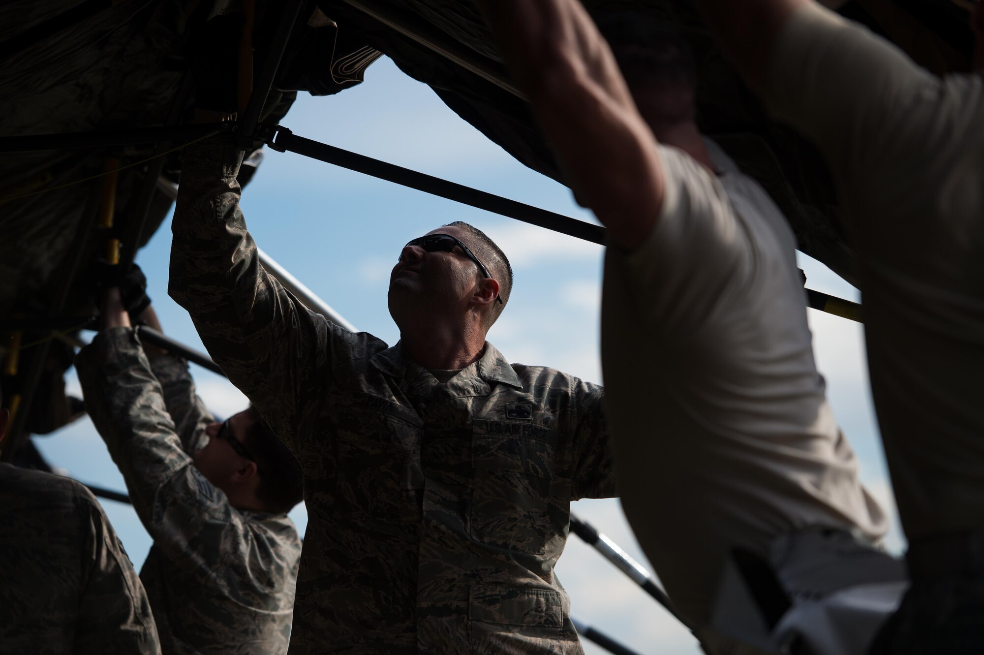 U.S. Air Force Master Sgt. Christopher Pavia,921st Contingency Response Squadron Maintenance Flight chief, helps set up a tent during Exercise Cerberus Strike 16-02 at the Fort Carson Air Terminal, Colo., Sept. 09, 2016. C-Strike is a joint exercise where contingency response forces rehearsed potential real-world situations by training with Army counterparts in cargo uploading and downloading on aircraft, aircraft engine running off-loads, communications, aerial port procedures, and air mobility liaison officer operations with airdrops from aircraft. (U.S. Air Force photo by Master Sgt. Joseph Swafford)