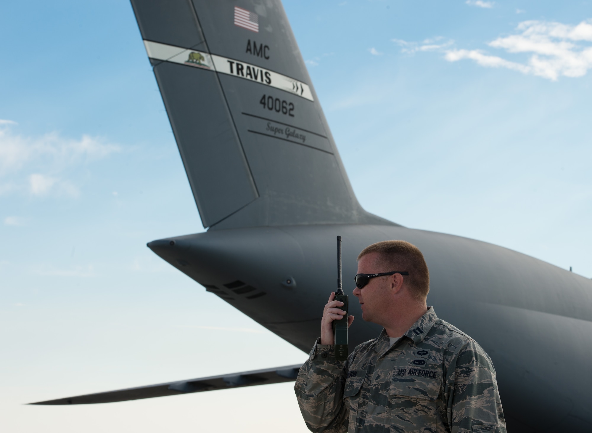 U.S. Air Force Capt. David Nelson, 821st Contingency Response Group executive officer, radios back to the Air Transportation Operations Center during Cerberus Strike 16-02 at the Fort Carson Air Terminal, Colo., Sept. 11, 2016. C-Strike is a joint exercise where contingency response forces rehearsed potential real-world situations by training with Army counterparts in cargo uploading and downloading on aircraft, aircraft engine running off-loads, communications, aerial port procedures, and air mobility liaison officer operations with airdrops from aircraft. (U.S. Air Force photo by Master Sgt. Joseph Swafford)