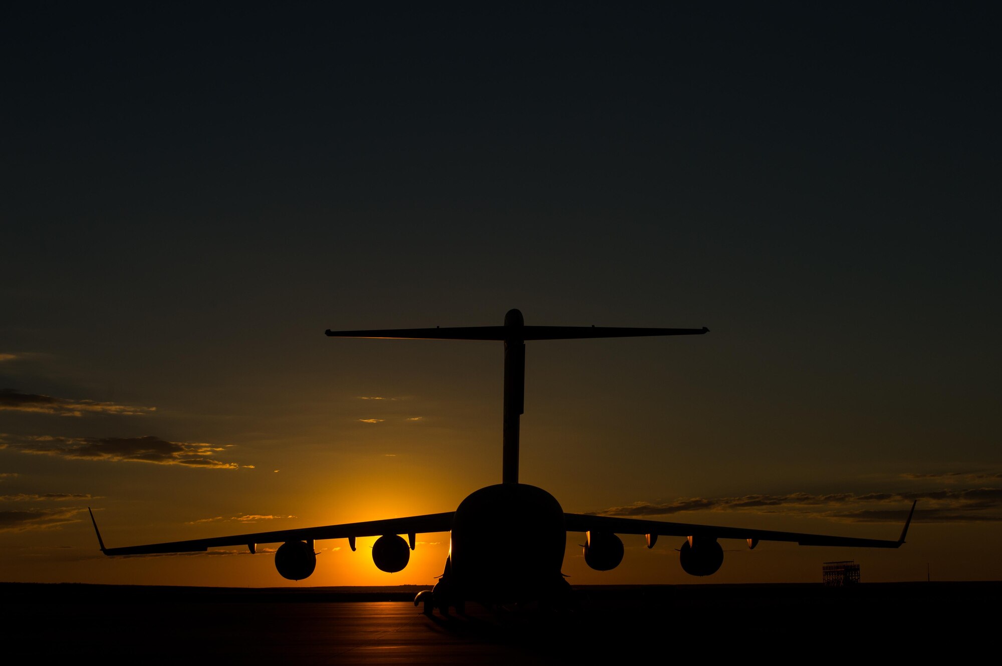 A C-17 Globemaster III aircraft sits on the parking ramp before a mission during Exercise Cerberus Strike 16-02 at the Fort Carson Air Terminal, Colo., Sept. 16, 2016. C-Strike is a joint exercise where contingency response forces rehearsed potential real-world situations by training with Army counterparts in cargo uploading and downloading on aircraft, aircraft engine running off-loads, communications, aerial port procedures, and air mobility liaison officer operations with airdrops from aircraft. (U.S. Air Force photo by Master Sgt. Joseph Swafford) 