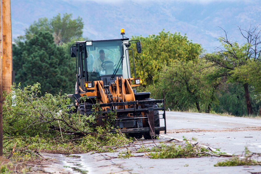 Debris is removed from a roadway on Hill Air Force Base, Utah, following a storm during the afternoon commute. The storm resulted in power outages, traffic delays, and damage across the base. (U.S. Air Force photo by Paul Holcomb)