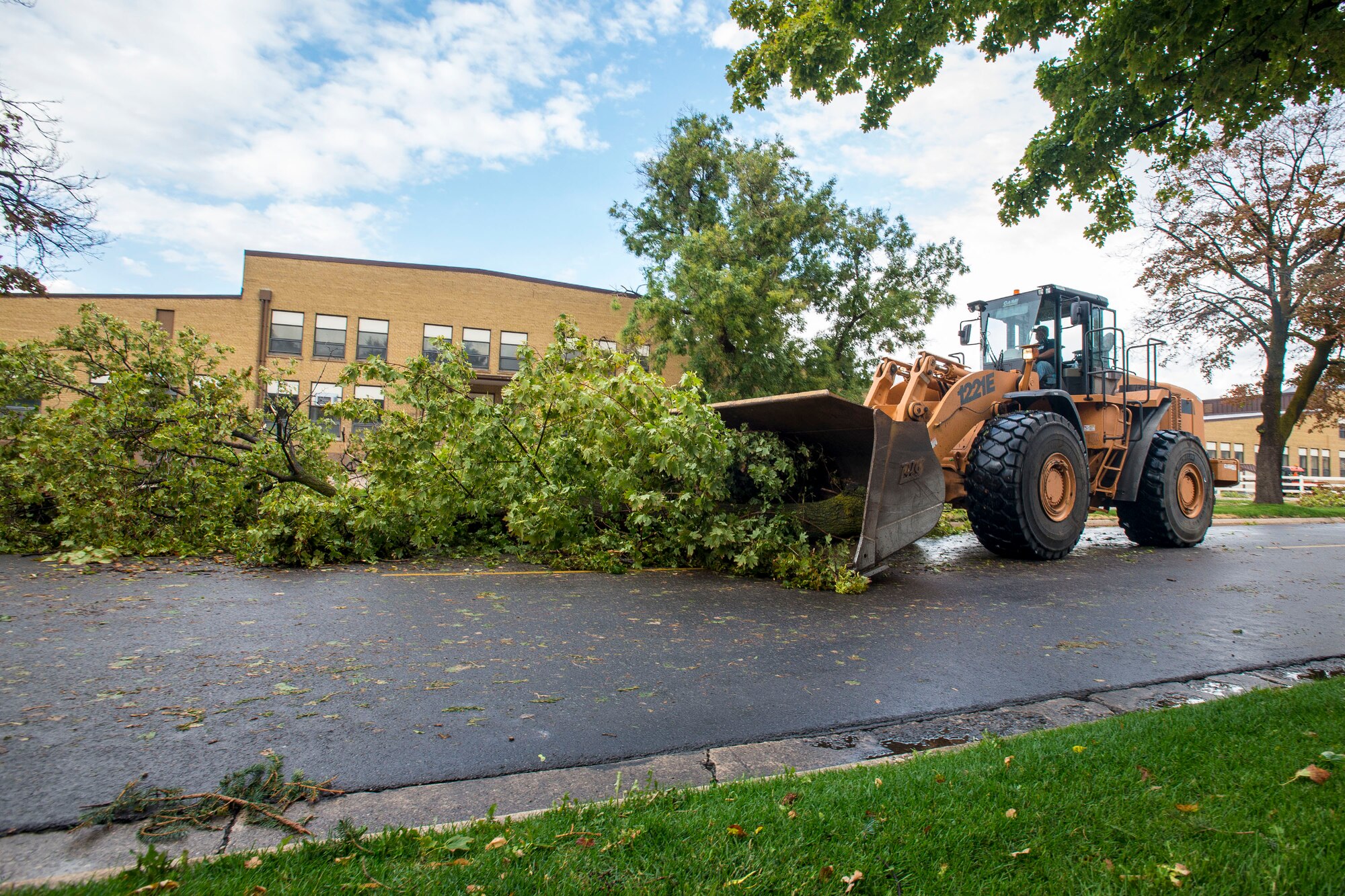 Kevin Miles, 75th Civil Engineer Squadron, removes tree limbs from 4th Street on Hill Air Force Base, Sept. 22, following an afternoon storm. The storm produced 77 mph winds and 1.89 inches of rain. Some areas of the base reported hail measuring three-fourths of an inch in diameter. (U.S. Air Force photo by Paul Holcomb)
