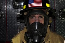 Airman 1st Class Travis Dyer suits up during a training session at Maxwell Air Force Base, 23 September. His team will compete in the Scott Safety Firefighter Combat Challenge in Montgomery, 24-29 October. (U.S. Air Force photo by Senior Airman Wililam Blankenship)