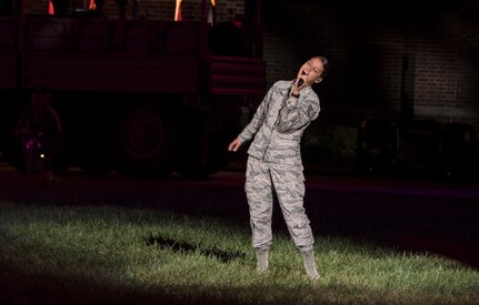 Tech Sgt. Nalani Quintello, U.S. Air Force Band Max Impact vocalist, sings during the 2016 U.S. Air Force Tattoo at Joint Base Anacostia-Bolling, Washington, D.C., Sept. 22. Max Impact, the U.S. Air Force Band’s premier rockband, performed three of their original songs, “Freedom,” “American Airman,” and “When They Come Home” during the event. 