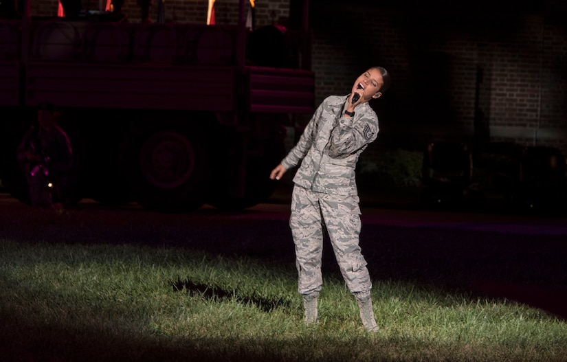 Tech Sgt. Nalani Quintello, U.S. Air Force Band Max Impact vocalist, sings during the 2016 U.S. Air Force Tattoo at Joint Base Anacostia-Bolling, Washington, D.C., Sept. 22. Max Impact, the U.S. Air Force Band’s premier rockband, performed three of their original songs, “Freedom,” “American Airman,” and “When They Come Home” during the event. 
