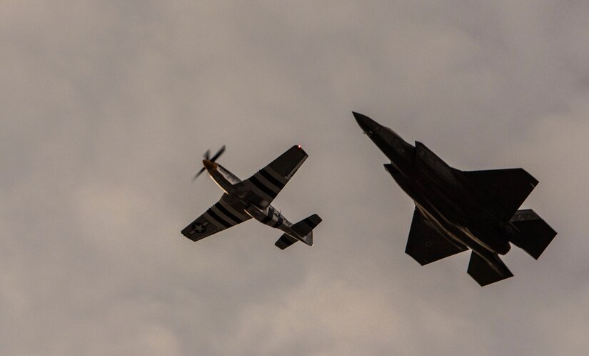 A P-51 Mustang, left, and an F-35 Lightning II, right, perform a flyover during the 2016 U.S. Air Force Tattoo at Joint Base Anacostia-Bolling, Washington, D.C., Sept. 22, 2016. The side-by-side flight of a World War II and present-day aircraft demonstrated the Air Force’s history and heritage. 