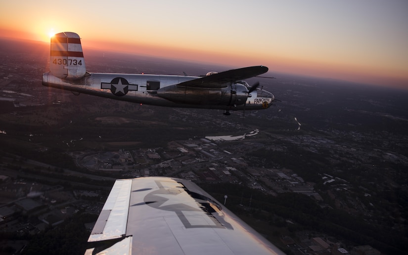 A B-25 Mitchell flies alongside a P-51 Mustang over the National Capital Region for a military tattoo held at Joint Base Anacostia-Bolling, Washington, D.C., Sept. 22, 2016. The B-25 and P-51 were part of the “Warbirds” tribute flight participating in the 2016 U.S. Air Force Tattoo celebrating the 69th birthday of the U.S. Air Force. 
