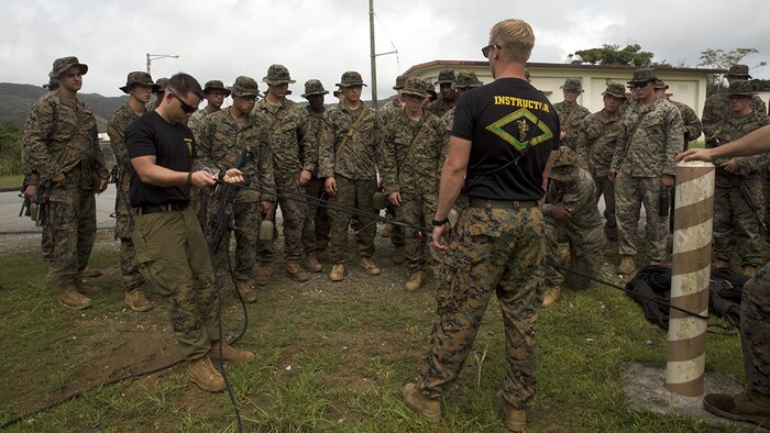 Instructors demonstrate how to set up a pulley system to retain equipment in the jungle Sept. 20 at the Jungle Warfare Training Center, Okinawa, Japan. The Jungle Warfare Training Center has provided terrain and climate-specific training to units serving across the Asia-Pacific region since 1958 and stretches over more than 17,000 acres. Training aboard the installation reinforces service members’ ability to carry out tactical operations in a jungle environment. 