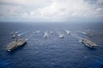 PHILIPPINE SEA -- USS Ronald Reagan (CVN 76) and USS Bonhomme Richard (LHD 6) lead a formation of Carrier Strike Group Five and Expeditionary Strike Group Seven ships including, USS Momsen (DDG 92), USS Chancellorsville (CG 62), USS Stethem (DDG 63), USS Benfold (DDG 65), USS Curtis Wilbur (DDG 54), USS Germantown (LSD 42), USS Barry (DDG 52), USS Green Bay (LPD 20), USS McCampbell (DDG 85), as wells as USNS Walter S. Diehl (T-AO 193) during a photo exercise to signify the completion of Valiant Shield 2016. Valiant Shield is a biennial, U.S. only, field-training exercise with a focus on integration of joint training among U.S. forces. This is the sixth exercise in the Valiant Shield series that began in 2006. 