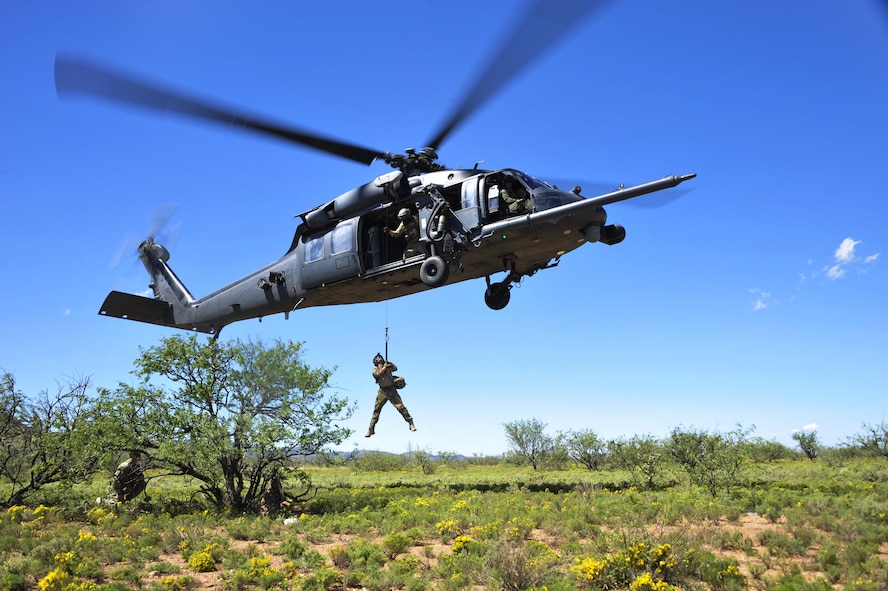 U.S. Air Force 1st Lt. Jaron Jablonski, 55th Rescue Squadron HH-60G Pave Hawk co-pilot, is hoisted into an HH-60G Pave Hawk from the 55th Rescue Squadron during a search and rescue exercise at Outlaw/Jackal military operations area in southeastern Ariz., Sept. 15, 2016. During the exercise Jablonski played as the survivor whose goal was to use tools he learned during survival, evasion, resistance and escape to evade the simulated enemy until rescue assets arrived. (U.S. Air Force photo by Senior Airman Cheyenne A. Powers)