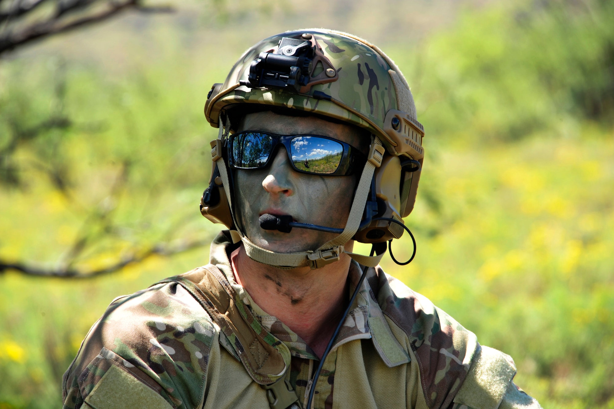 U.S. Air Force 1st Lt. Jaron Jablonski, 55th Rescue Squadron HH-60G Pave Hawk co-pilot, waits in concealment for rescue assets to arrive during a search and rescue exercise at Outlaw/Jackal military operations area in southeastern Ariz., Sept. 15, 2016. During the exercise Jablonski played as the survivor whose goal was to use tools he learned during survival, evasion, resistance and escape to evade the simulated enemy until rescue assets arrived. (U.S. Air Force photo by Senior Airman Cheyenne A. Powers)