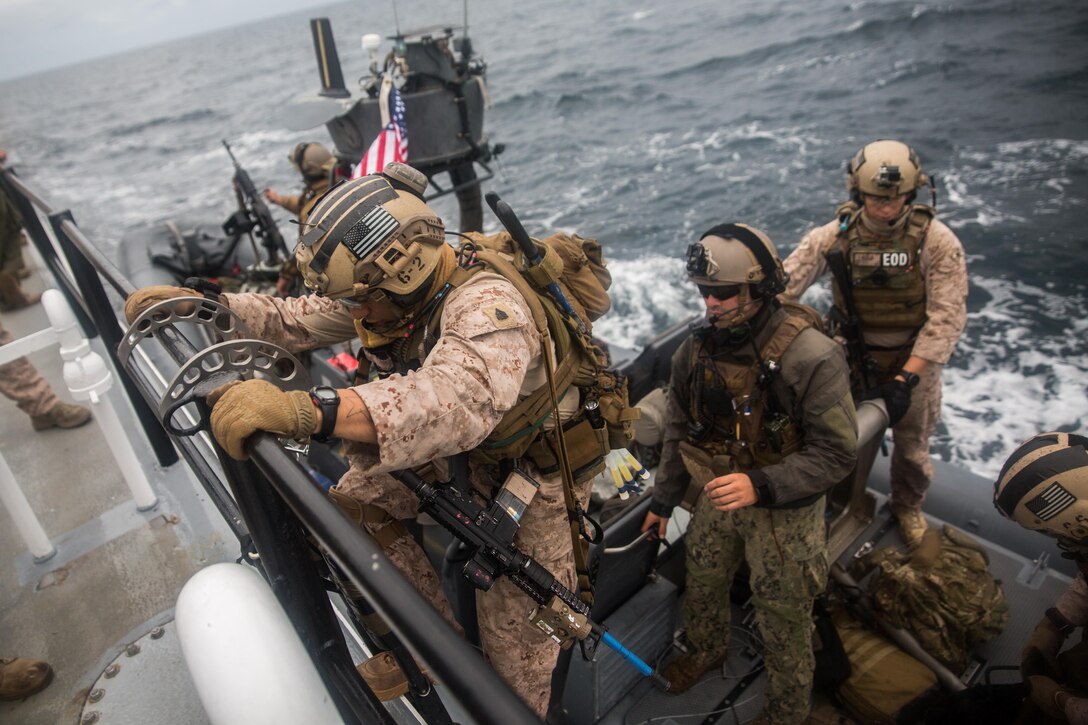 AT SEA, Pacific Ocean (September 12, 2016) – A Marine with Maritime Raid Force, 11th Marine Expeditionary Unit, climbs aboard a rigid-hulled inflatable boat following a Visit, Board, Search, and Seizure mission executed off the coast of San Clemente Island, Calif., as part of the 11th MEU’s Certification Exercise, Sept. 13, 2016. VBSS missions can be conducted if a ship is suspected smuggling illicit cargo. Once a vessel has been cleared of an enemy threat and searched for weapons and high-value individuals, the ship will then be turned over to host-nation security forces. (US Marine Corps photo by Lance Cpl. Devan K. Gowans/Released)