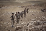Soldiers from the Nineveh Plain Protection Unit patrol a mountainside during a react to contact training exercise at their training facility in the Nineveh Province, May 18, 2016.  The NPPU are a small group of fighters who came together to protect their people in the fight against the Islamic State of Iraq and the Levant.  Training focused on the Combined Joint Task Force – Operation Inherent Resolve overall mission to build partner capacity and increase the military capacity of local forces fighting ISIL.  (U.S. Army photo by Staff Sgt. Sergio Rangel)