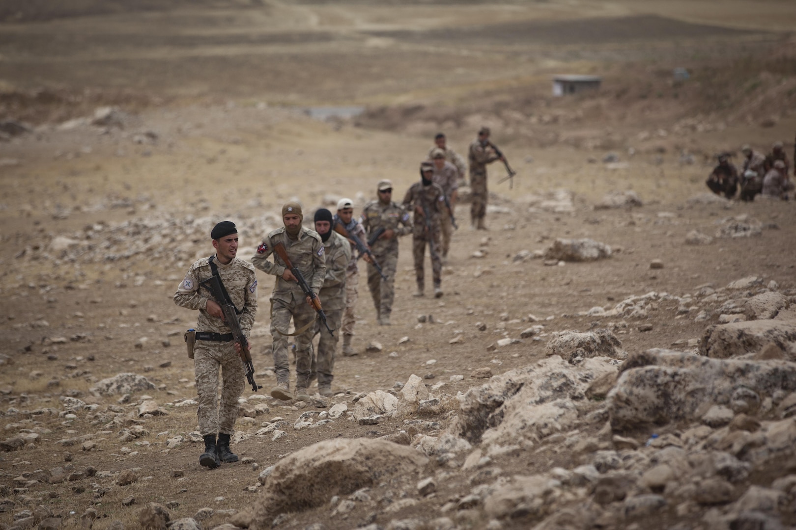 Soldiers from the Nineveh Plain Protection Unit patrol a mountainside during a react to contact training exercise at their training facility in the Nineveh Province, May 18, 2016.  The NPPU are a small group of fighters who came together to protect their people in the fight against the Islamic State of Iraq and the Levant.  Training focused on the Combined Joint Task Force – Operation Inherent Resolve overall mission to build partner capacity and increase the military capacity of local forces fighting ISIL.  (U.S. Army photo by Staff Sgt. Sergio Rangel)
