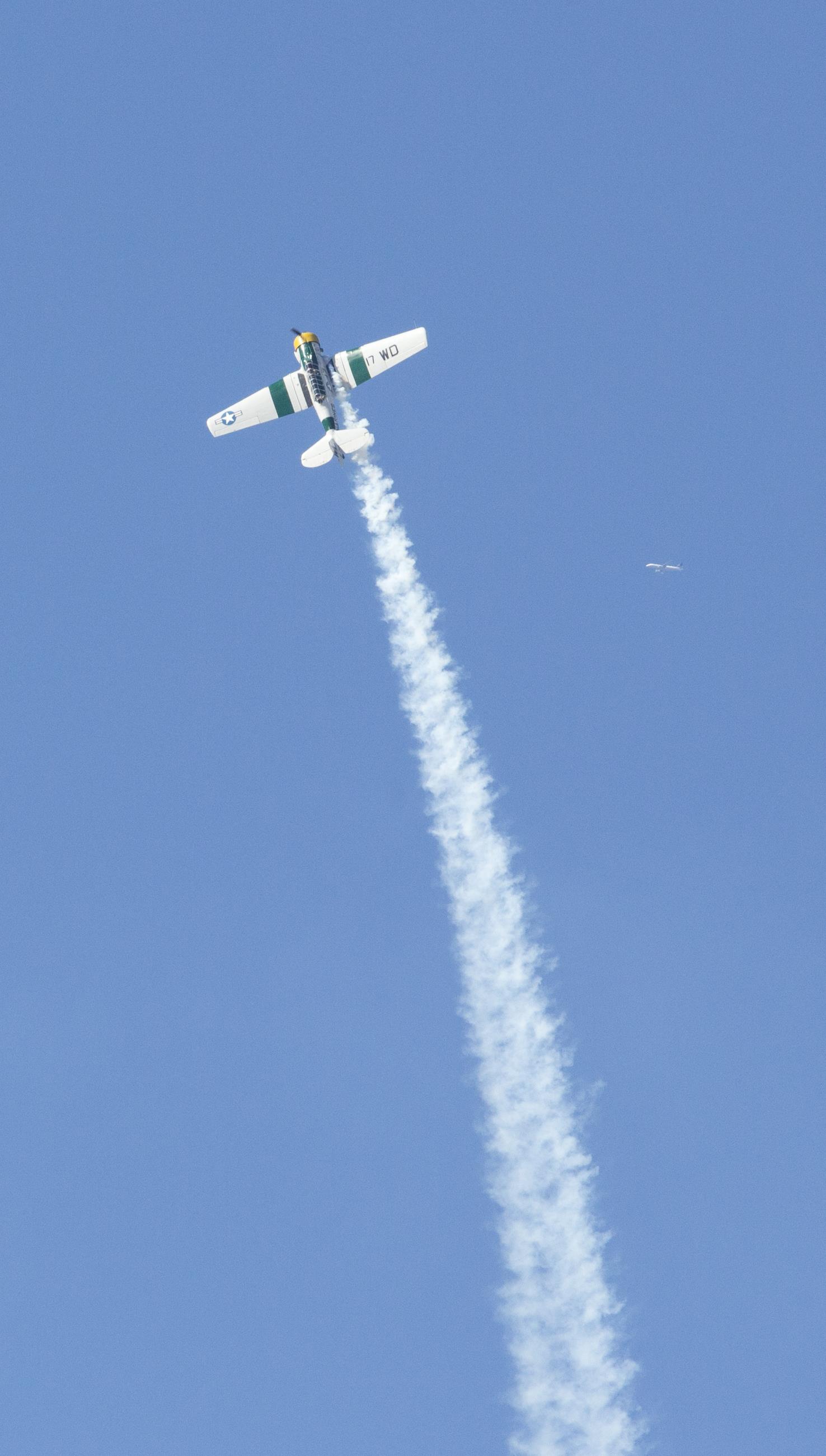 John Collver soars above the flight line in an AT-6 Texan “War Dog” during his performance at the 2016 MCAS Miramar Air Show aboard Marine Corps Air Station Miramar, Calif., Sept. 24. Collver uses the World War II-era aircraft to demonstrate the aerial maneuvers taught to dogfighting American pilots more than 60 years ago. The MCAS Miramar Air Show showcases world-class performers, military flight demonstration teams, the capabilities of the Marine Air-Ground Task Force and celebrates Miramar’s longstanding relationship with the local San Diego community. (U.S. Marine Corps photo by Sgt. Brytani Wheeler/Released)