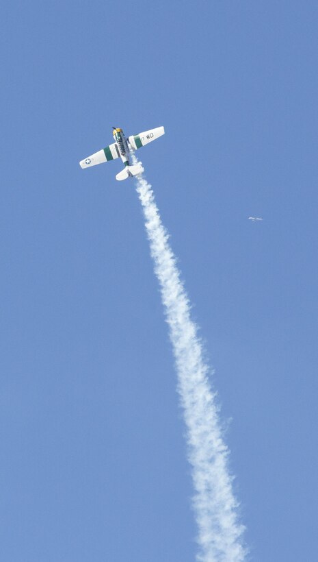 John Collver soars above the flight line in an AT-6 Texan “War Dog” during his performance at the 2016 MCAS Miramar Air Show aboard Marine Corps Air Station Miramar, Calif., Sept. 24. Collver uses the World War II-era aircraft to demonstrate the aerial maneuvers taught to dogfighting American pilots more than 60 years ago. The MCAS Miramar Air Show showcases world-class performers, military flight demonstration teams, the capabilities of the Marine Air-Ground Task Force and celebrates Miramar’s longstanding relationship with the local San Diego community. (U.S. Marine Corps photo by Sgt. Brytani Wheeler/Released)