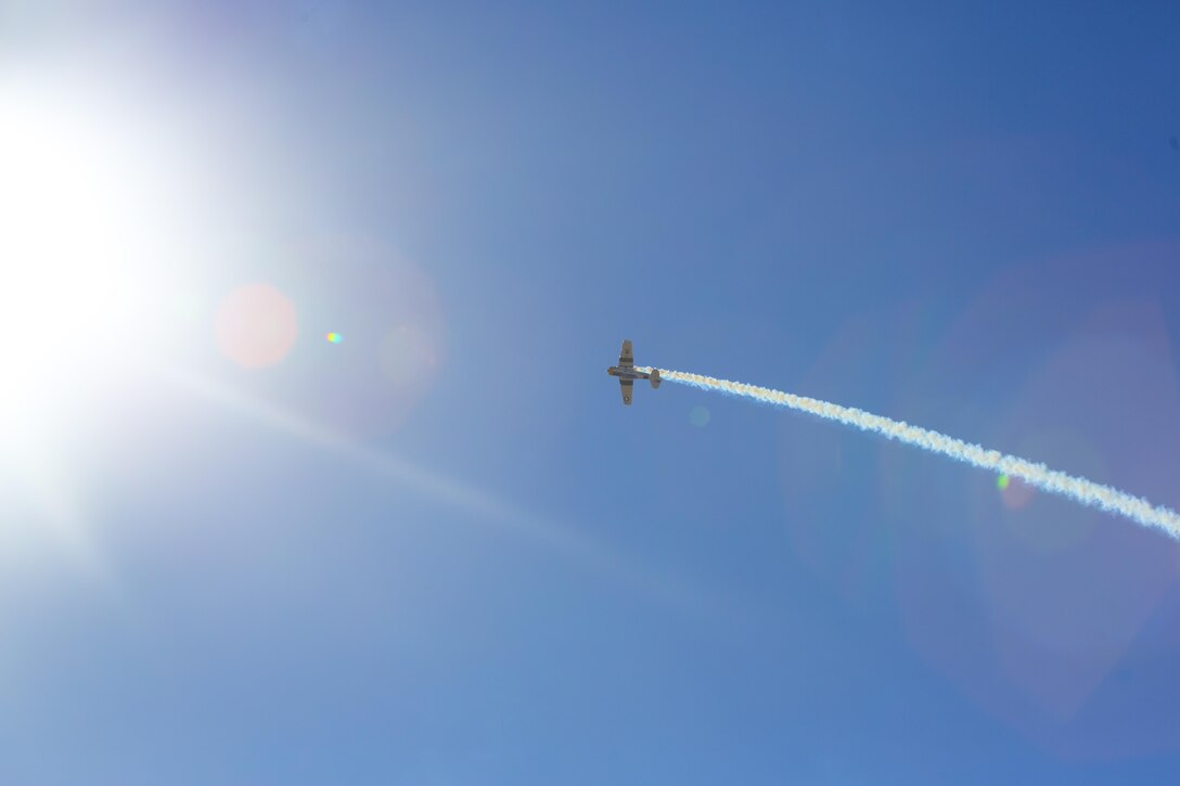 John Collver soars above the flight line in an AT-6 Texan “War Dog” during his performance at the 2016 MCAS Miramar Air Show aboard Marine Corps Air Station Miramar, Calif., Sept. 24. Collver uses the World War II-era aircraft to demonstrate the aerial maneuvers taught to dogfighting American pilots more than 60 years ago. The MCAS Miramar Air Show showcases world-class performers, military flight demonstration teams, the capabilities of the Marine Air-Ground Task Force and celebrates Miramar’s longstanding relationship with the local San Diego community. (U.S. Marine Corps photo by Sgt. Brytani Wheeler/Released)