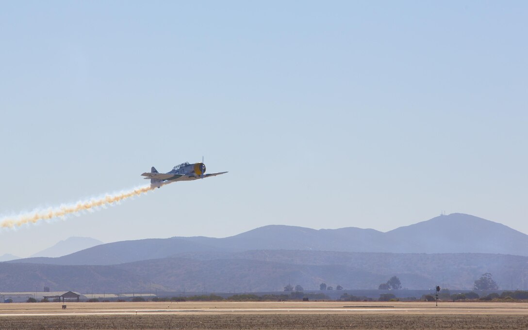 John Collver soars above the flight line in an AT-6 Texan “War Dog” during his performance at the 2016 MCAS Miramar Air Show aboard Marine Corps Air Station Miramar, Calif., Sept. 24. Collver uses the World War II-era aircraft to demonstrate the aerial maneuvers taught to dogfighting American pilots more than 60 years ago. The MCAS Miramar Air Show showcases world-class performers, military flight demonstration teams, the capabilities of the Marine Air-Ground Task Force and celebrates Miramar’s longstanding relationship with the local San Diego community. (U.S. Marine Corps photo by Sgt. Brytani Wheeler/Released)
