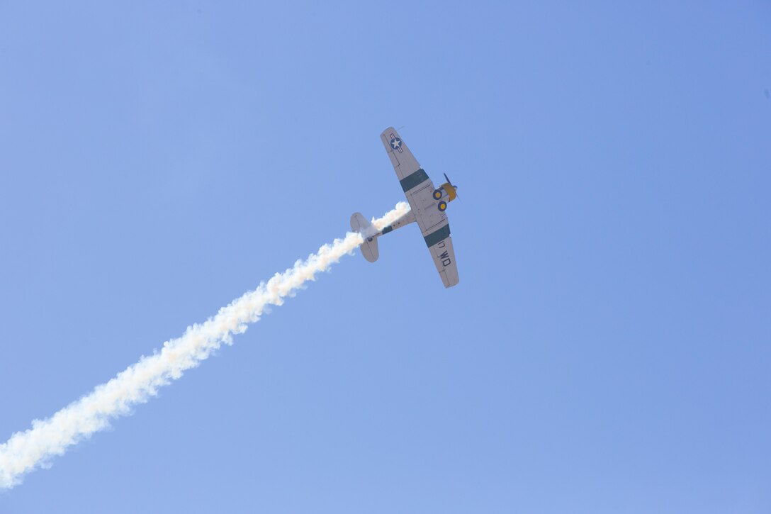 John Collver soars above the flight line in an AT-6 Texan “War Dog” during his performance at the 2016 MCAS Miramar Air Show aboard Marine Corps Air Station Miramar, Calif., Sept. 24. Collver uses the World War II-era aircraft to demonstrate the aerial maneuvers taught to dogfighting American pilots more than 60 years ago. The MCAS Miramar Air Show showcases world-class performers, military flight demonstration teams, the capabilities of the Marine Air-Ground Task Force and celebrates Miramar’s longstanding relationship with the local San Diego community. (U.S. Marine Corps photo by Sgt. Brytani Wheeler/Released)