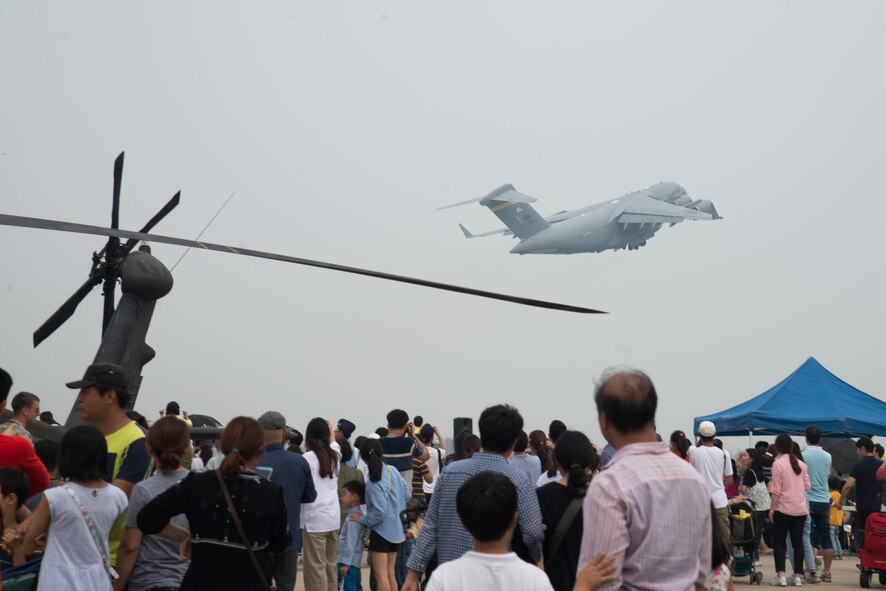 Air show attendees watch as a C-17 Globemaster III taxis in reverse after landing during Air Power Day 2016 at Osan Air Base, Republic of Korea. The C-17 has the capability to deploy personnel and cargo to locations across the world.  (U.S. Air Force photo by Senior Airman Dillian Bamman)