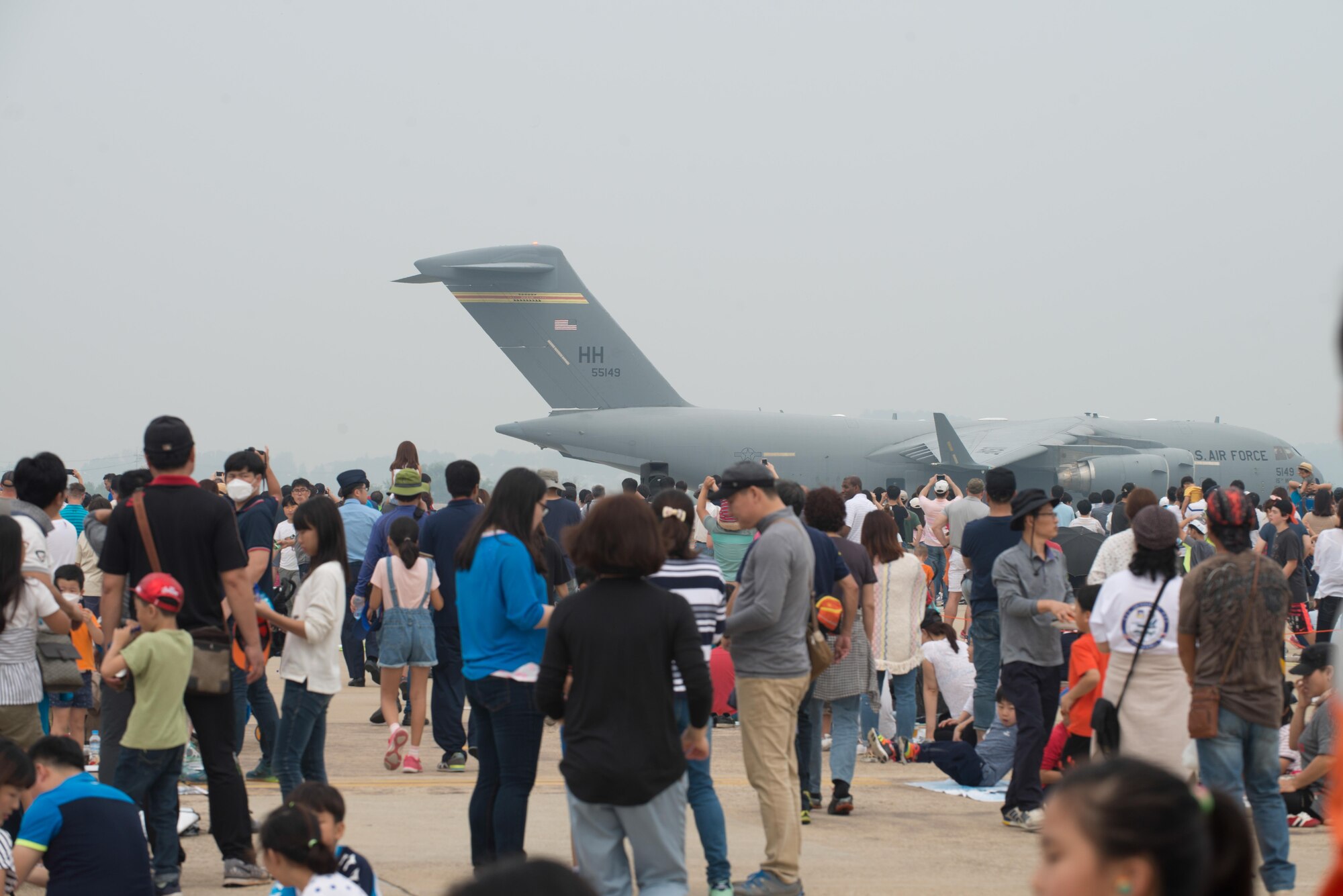 Air show attendees watch as a C-17 Globemaster III taxis in reverse after landing during Air Power Day 2016 at Osan Air Base, Republic of Korea. The C-17 has the capability to deploy personnel and cargo to locations across the world. (U.S. Air Force photo by Senior Airman Dillian Bamman)