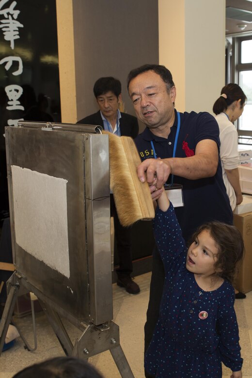 Joannabella Smith, a Marine Corps Air Station Iwakuni resident, makes paper at the Fudenosato Kobo Museum in Kumano, Japan, Sept. 22, 2016. During the visit at the Fudenosato Kobo Museum with the Cultural Adaptation Program, residents were able to see how the calligraphy paper, brushes and paint pods were made. The residents also enjoyed calligraphy, traditions, and history at the Kumano Brush Festival. (U.S. Marine Corps photo by Lance Cpl. Joseph Abrego) 